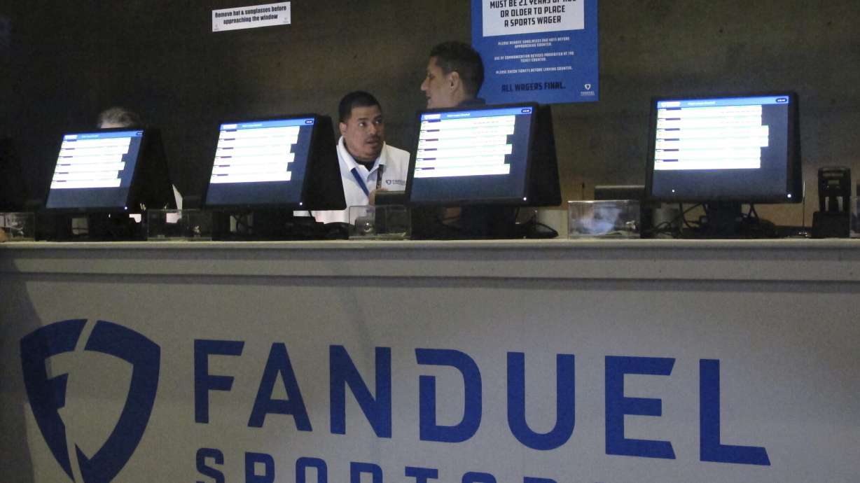 FILE - Workers at the FanDuel sports book at the Meadowlands Racetrack in East Rutherford, N.J., prepare to take bets, July 14, 2018.