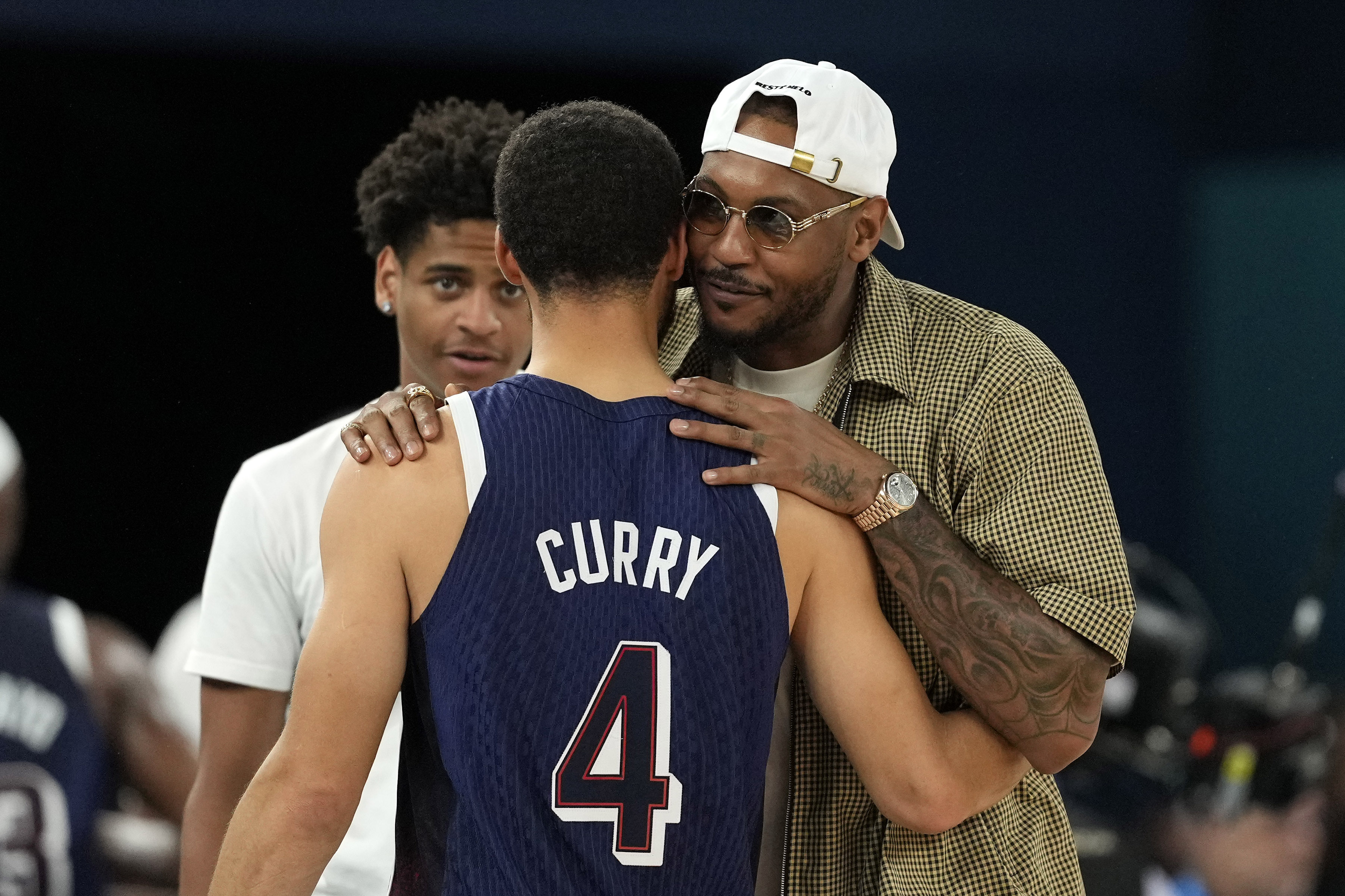 FILE - United States' Stephen Curry, center, greets Kiyan Anthony, left, and Carmelo Anthony, after the United States defeated Brazil in a men's basketball game at the 2024 Summer Olympics, Aug. 6, 2024, in Paris, France. 