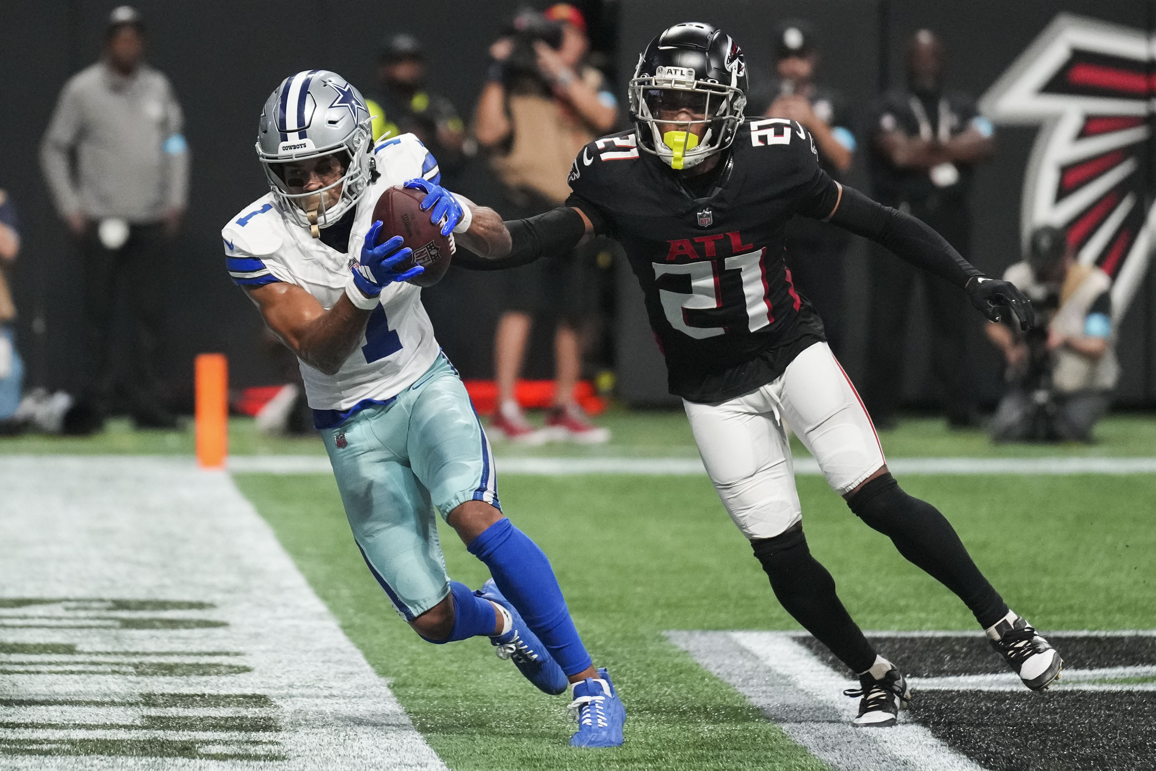 Dallas Cowboys wide receiver Jalen Tolbert (1) pulls in a touchdown reception against Atlanta Falcons cornerback Mike Hughes (21) during the second half of an NFL football game, Sunday, Nov. 3, 2024, in Atlanta.
