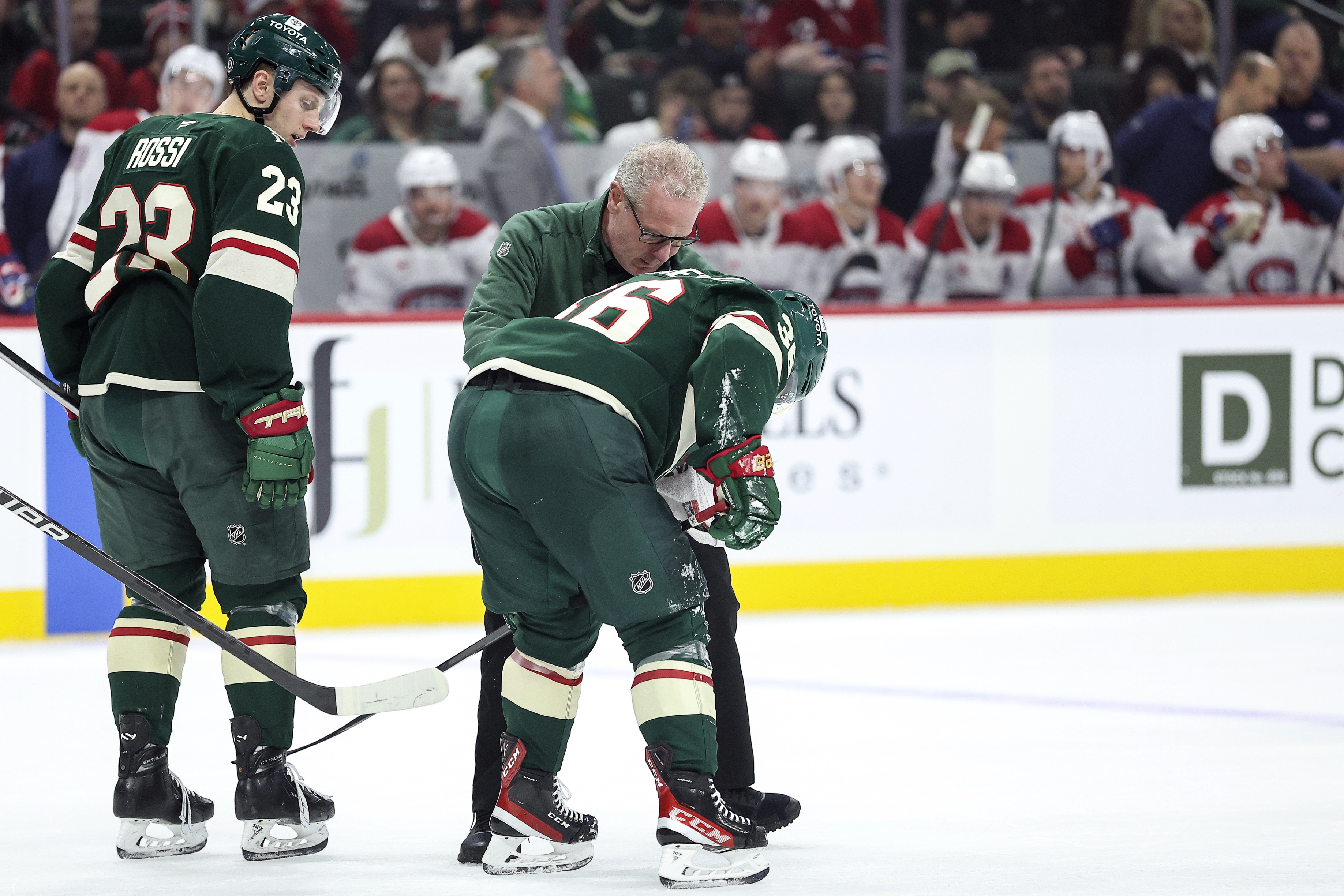 Minnesota Wild right wing Mats Zuccarello, center, is helped off the ice after suffering an injury during the first period of an NHL hockey game against the Montreal Canadiens Thursday, Nov. 14, 2024, in St. Paul, Minn. 