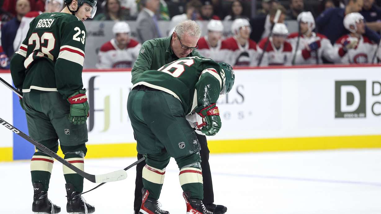 Minnesota Wild right wing Mats Zuccarello, center, is helped off the ice after suffering an injury during the first period of an NHL hockey game against the Montreal Canadiens Thursday, Nov. 14, 2024, in St. Paul, Minn.