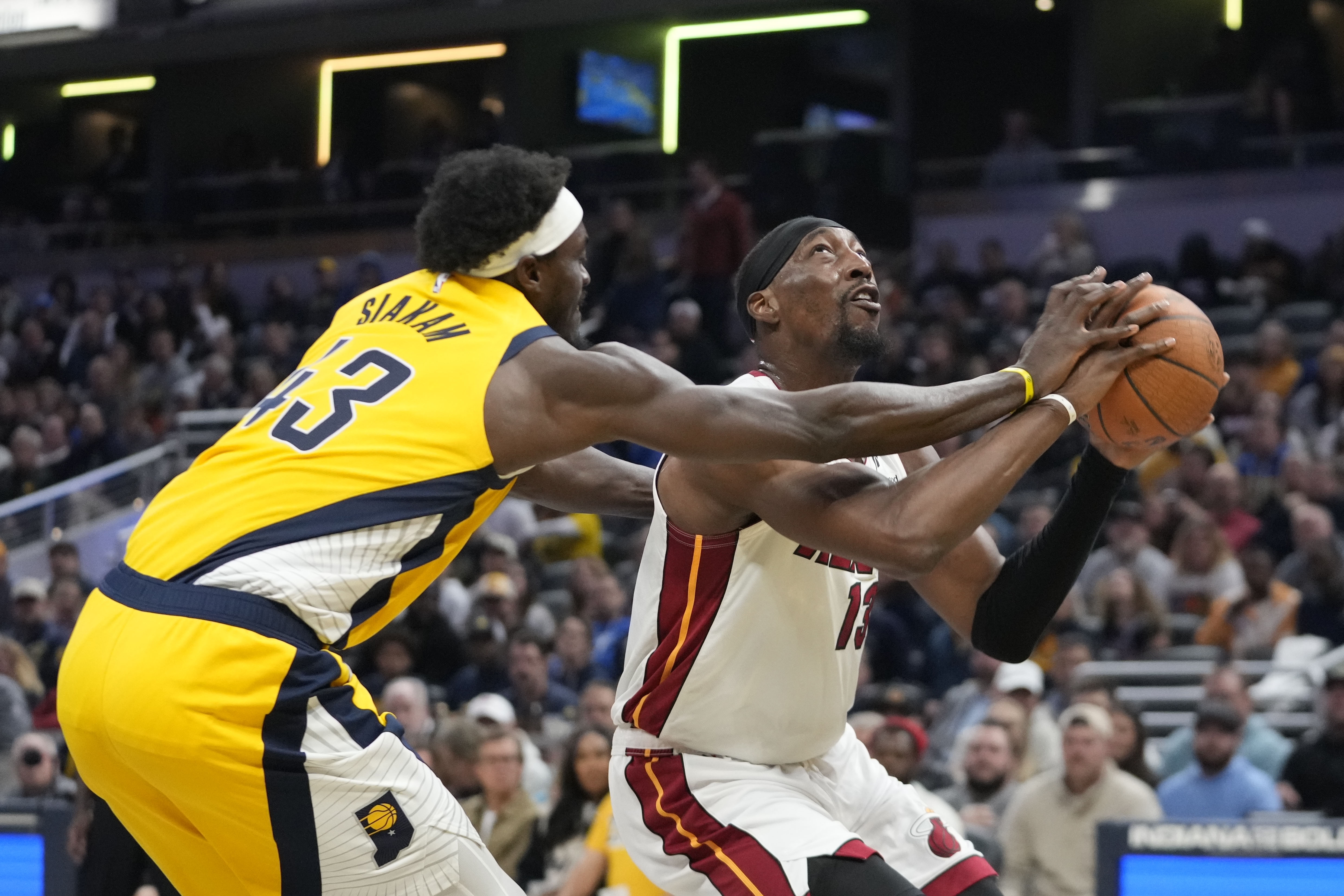 Miami Heat's Bam Adebayo (13) is fouled by Indiana Pacers' Pascal Siakam (43) during the first half of an Emirates NBA Cup basketball game, Friday, Nov. 15, 2024, in Indianapolis. 