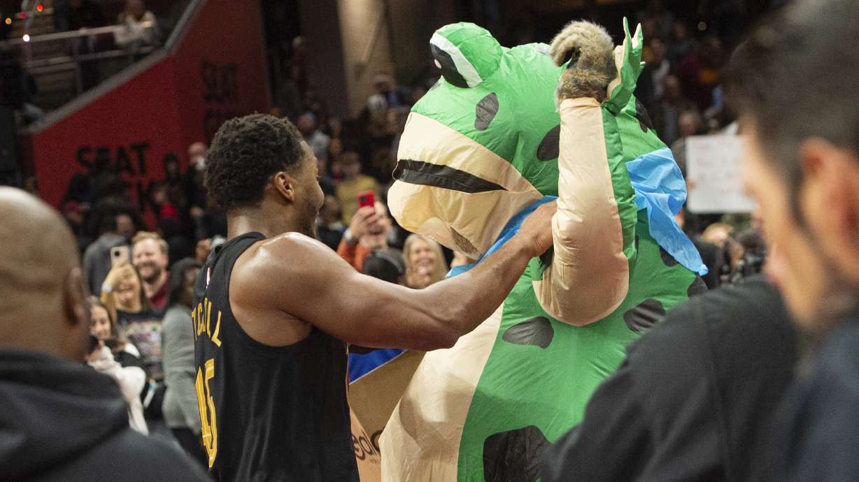 Cleveland Cavaliers' Donovan Mitchell, center left, dances with someone dressed as giant frog after an Emirates NBA cup basketball game against the Chicago Bulls in Cleveland, Friday, Nov 15, 2024.