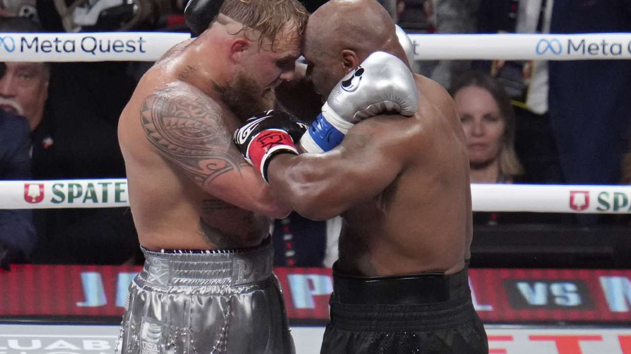Jake Paul and Mike Tyson embrace after their heavyweight boxing match, Friday, Nov. 15, 2024, in Arlington, Texas.