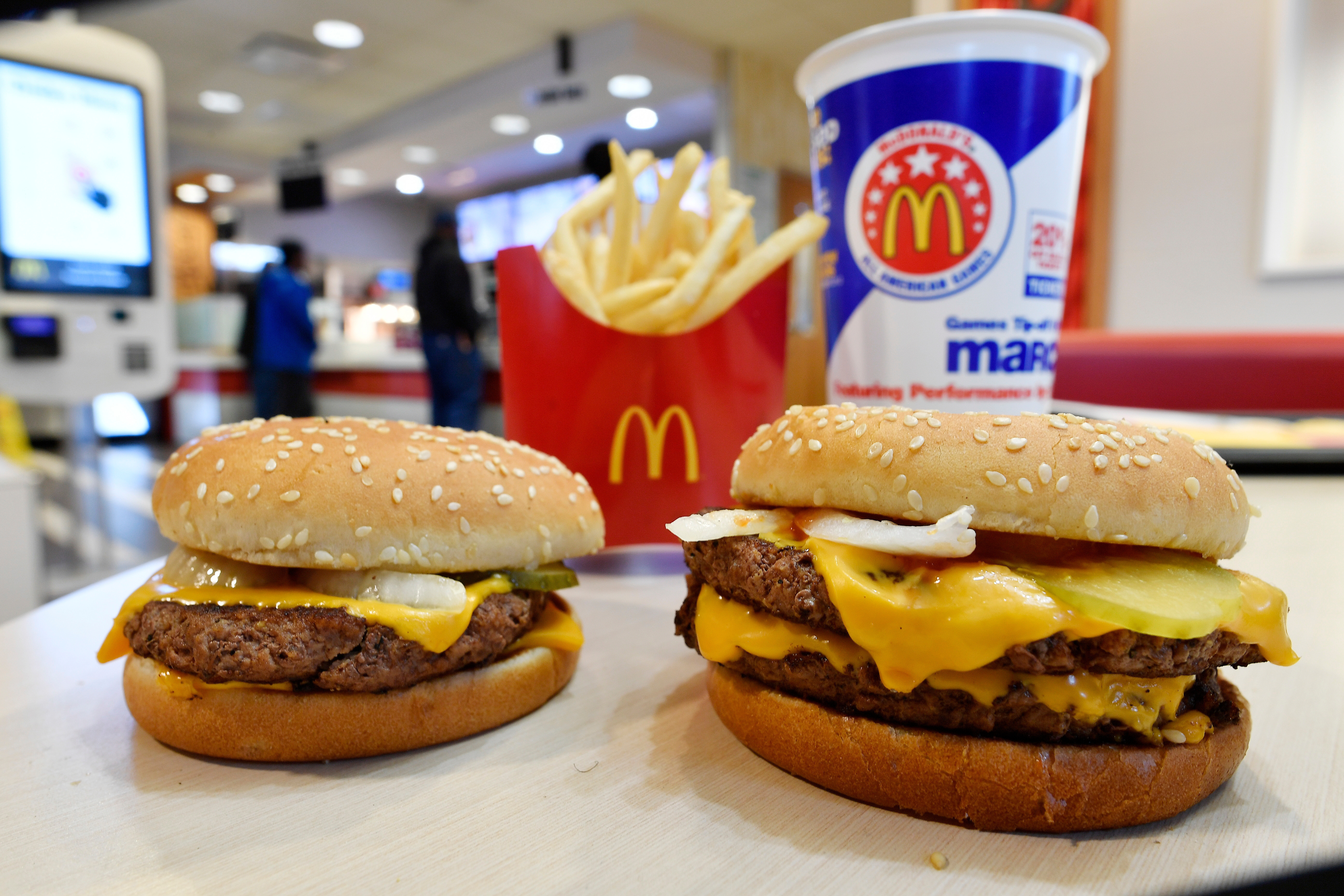 McDonald's is investing millions to bring customers back to restaurants following an E. coli outbreak tied to onions on the fast-food giant's Quarter Pounder hamburgers.