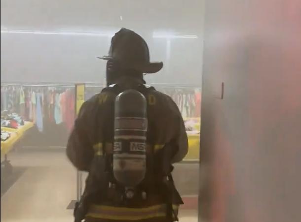 Screenshot from a video posted on social media shows firefighters entering the Value Vault in Taylorsville, full of smoke Saturday morning.