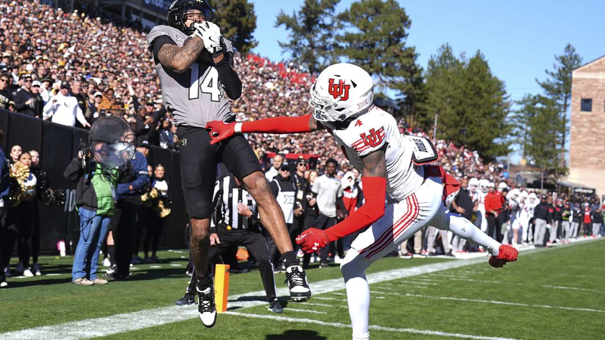 Colorado wide receiver Will Sheppard, left, pulls in a touchdown pass over Utah cornerback Cameron Calhoun in the first half of an NCAA college football game Saturday, Nov. 16, 2024, in Boulder, Colo.