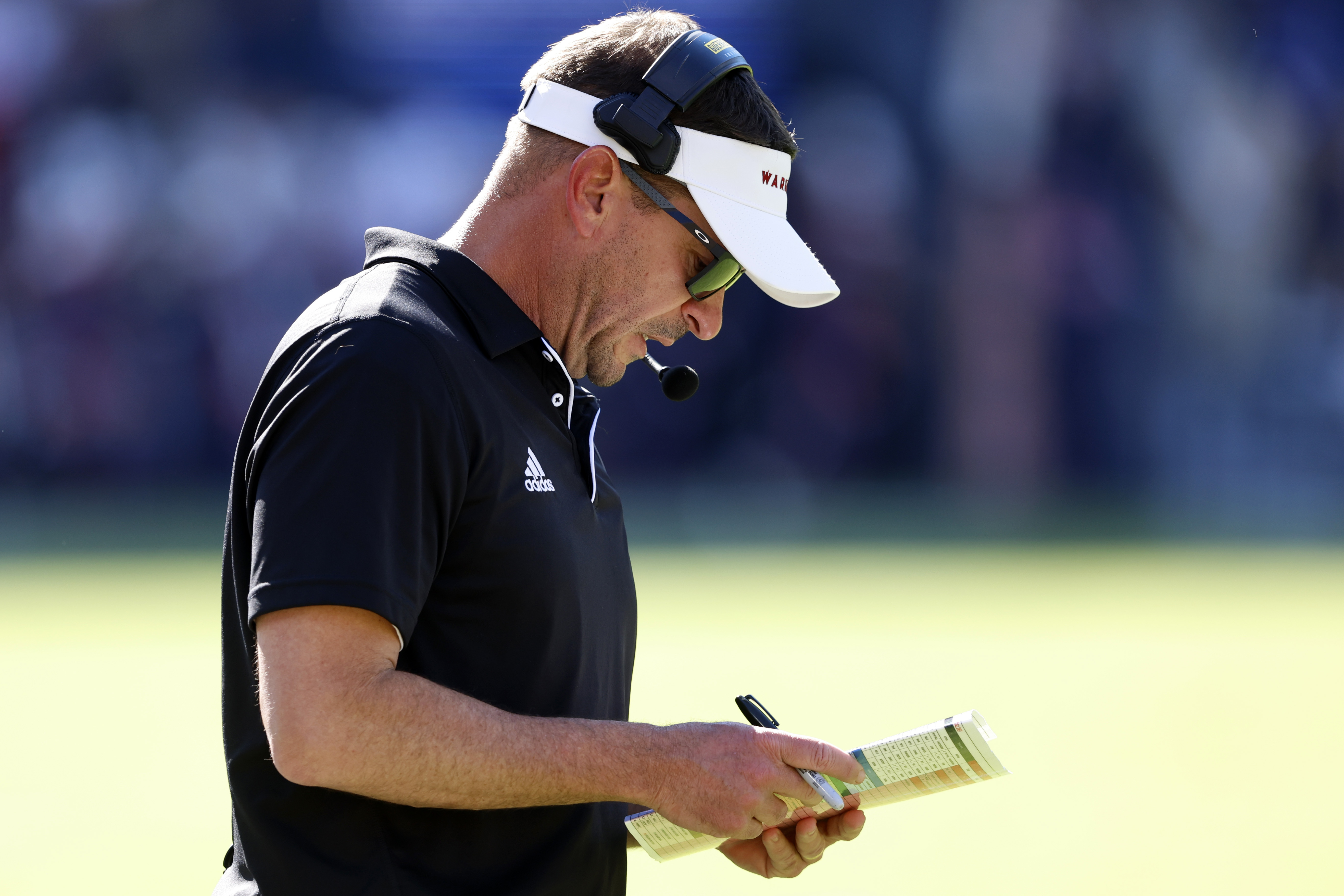 Louisiana Monroe head coach Bryant Vincent looks at his play card during the first half of an NCAA college football game against Auburn, Saturday, Nov. 16, 2024, in Auburn, Ala. 