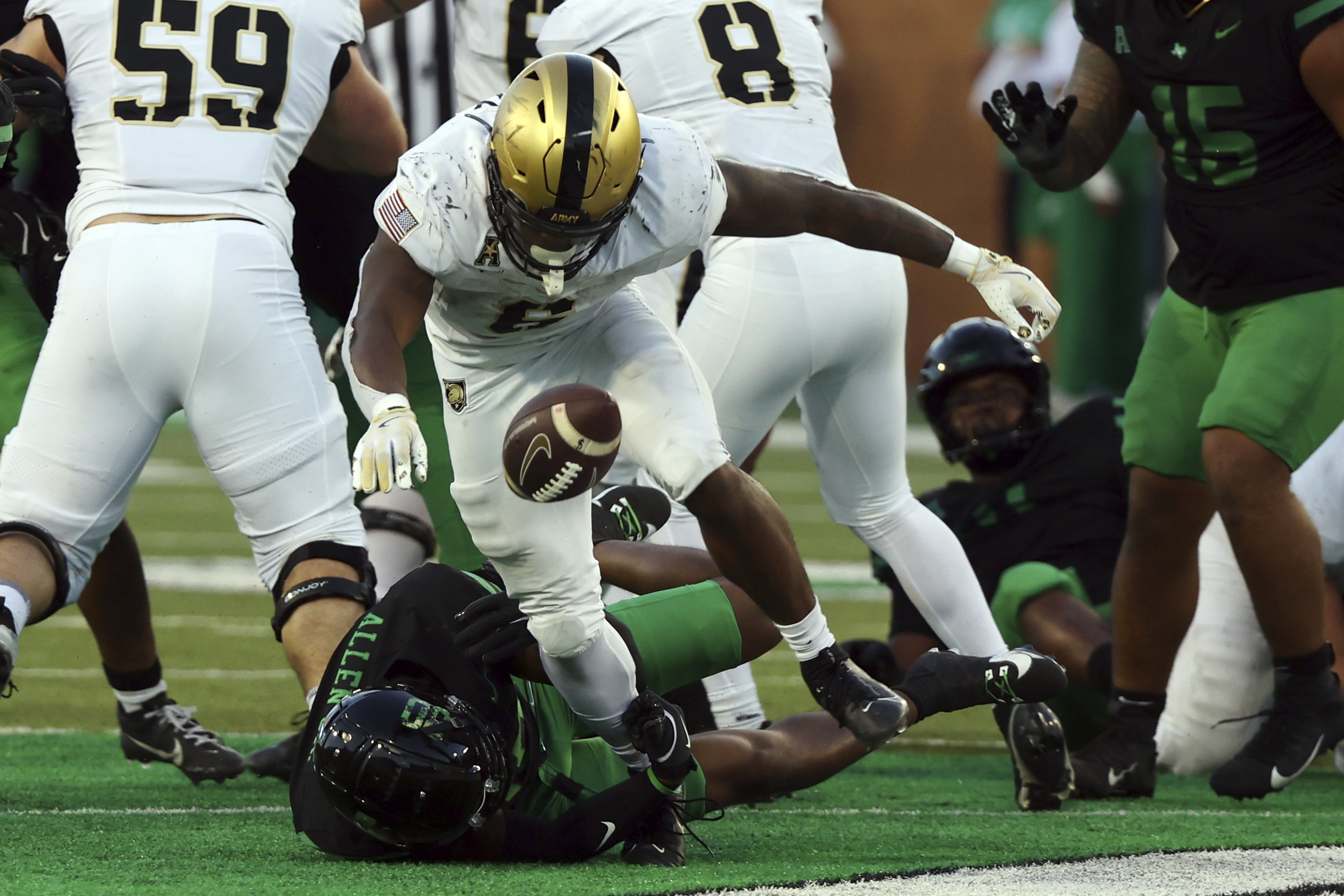 Army running back Kanye Udoh (6) fumbles the ball after being tackled by North Texas safety BJ Allen Jr. (30) in the second half of an NCAA football game Saturday, Nov. 9, 2024, in Denton, TX.