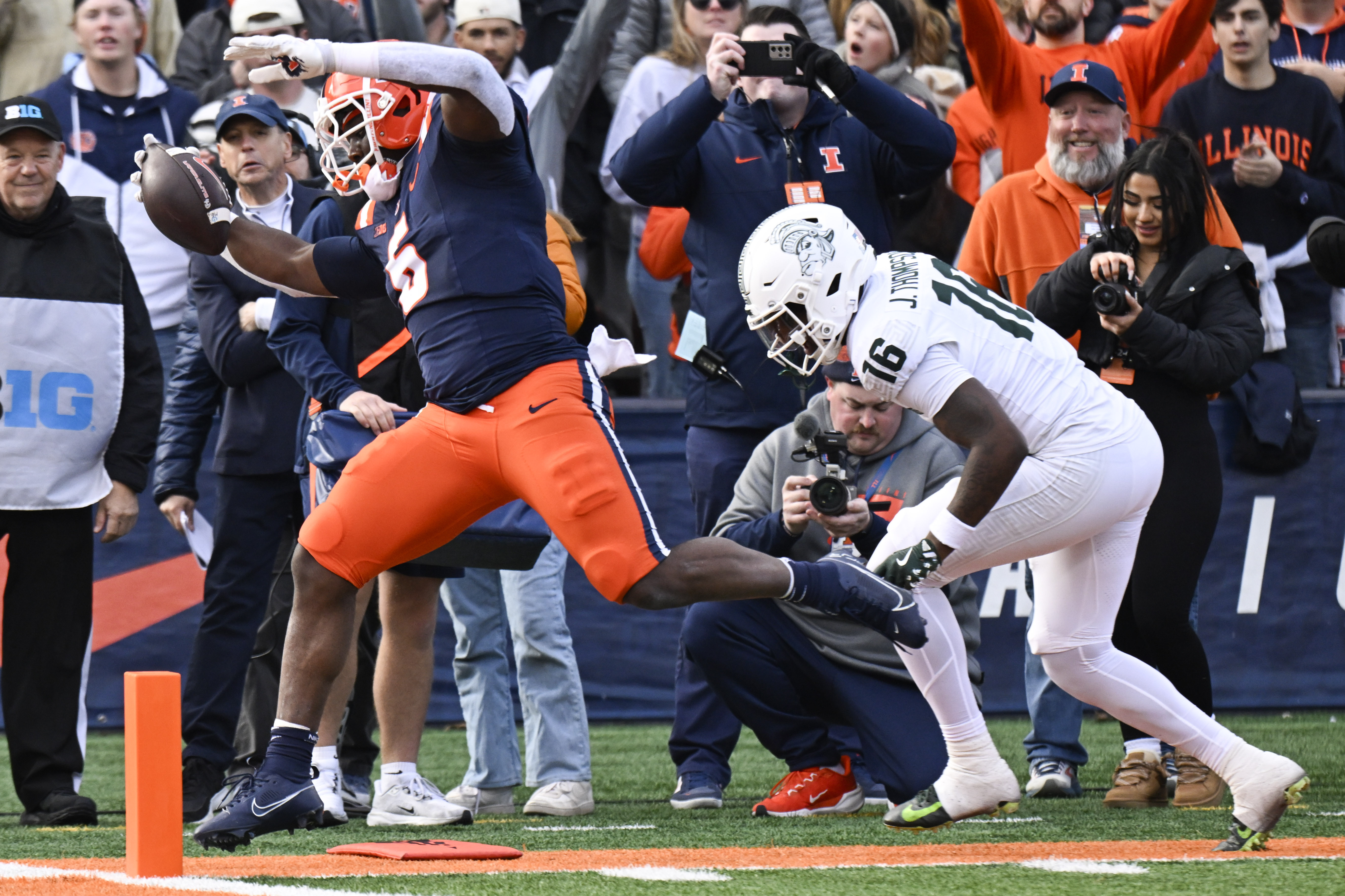 Illinois running back Ca'Lil Valentine (5) scores a touchdown ahead of Michigan State defensive back Jaylen Thompson (16) during the first half in an NCAA college football game, Saturday, Nov. 16, 2024, in Champaign, Ill. 