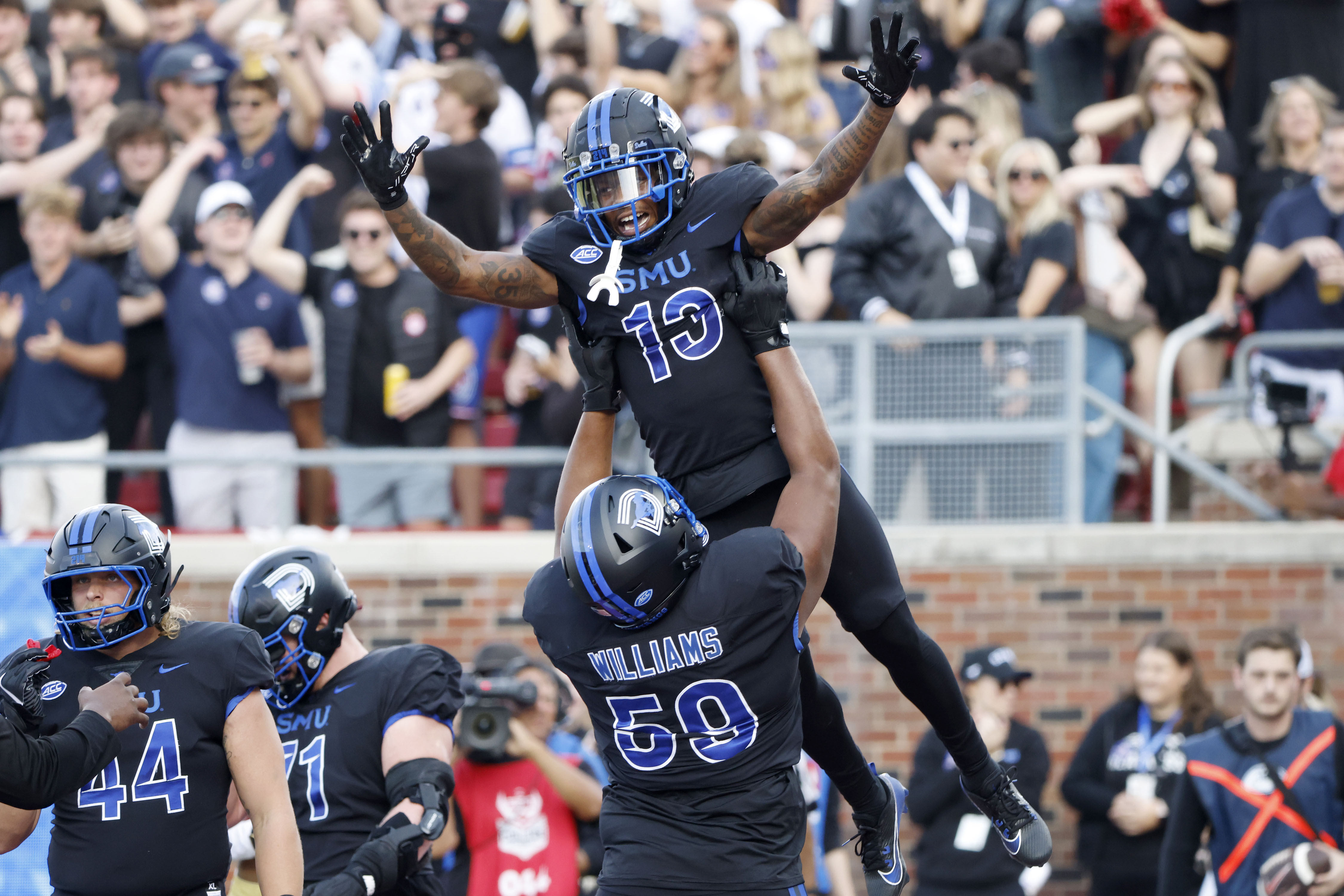 SMU wide receiver Roderick Daniels Jr. (13) celebrates after his touchdown reception with offensive lineman PJ Williams (59) during the first half of an NCAA college football game against Boston College in University Park, Texas, Saturday, Nov. 16, 2024. 