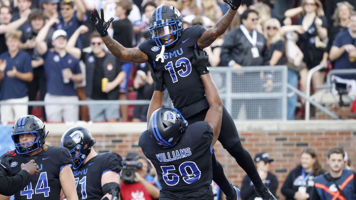 SMU wide receiver Roderick Daniels Jr. (13) celebrates after his touchdown reception with offensive lineman PJ Williams (59) during the first half of an NCAA college football game against Boston College in University Park, Texas, Saturday, Nov. 16, 2024.