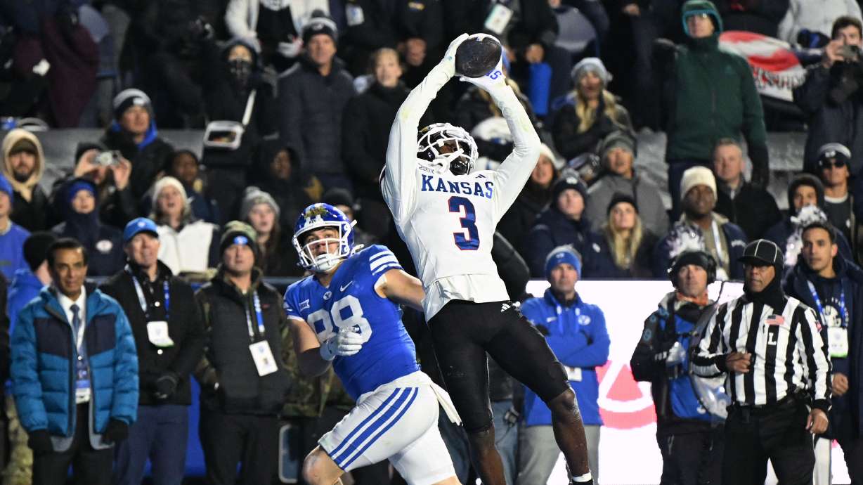 Kansas Jayhawks cornerback Mello Dotson (3) makes an interception in the end zone over Brigham Young Cougars tight end Mata'ava Ta'ase (88) just before the half as BYU and Kansas play at LaVell Edwards Stadium in Provo on Saturday, Nov. 16, 2024.