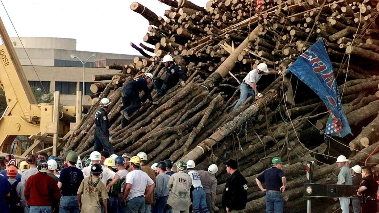 FILE - Texas A&M students and rescue workers gathered at the base of the collapsed bonfire stack as the search continues for victims in College Station, Texas, Nov. 18, 1999.