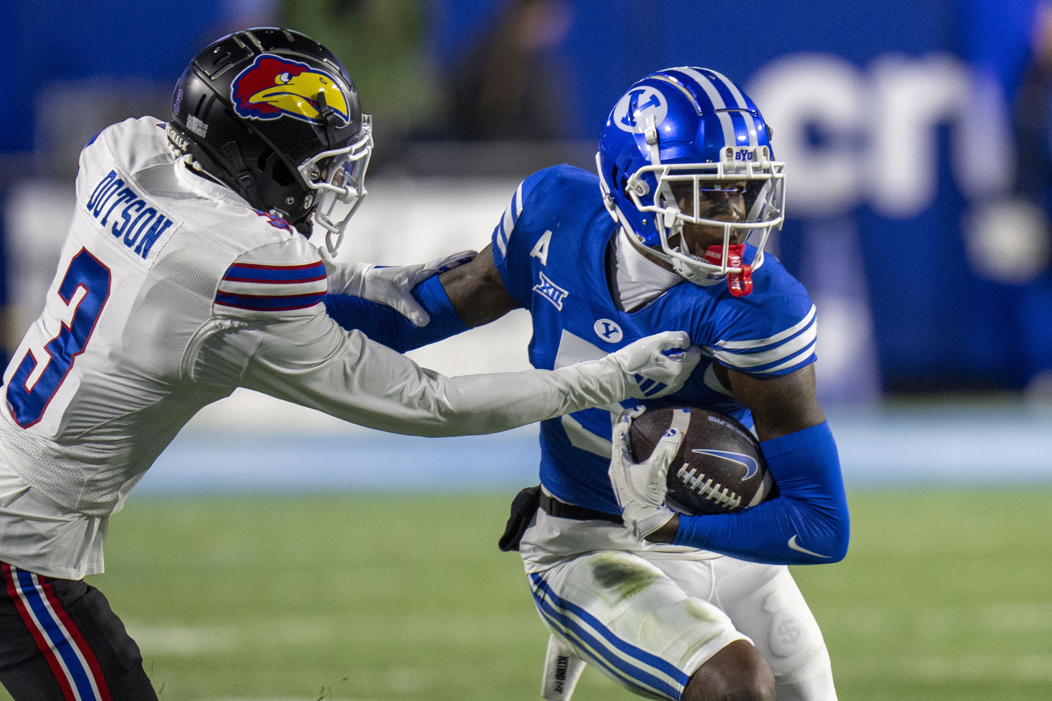 Kansas cornerback Mello Dotson (3) tackles BYU wide receiver Darius Lassiter (5) during the first half of an NCAA college football game Saturday, Nov. 16, 2024, in Provo.