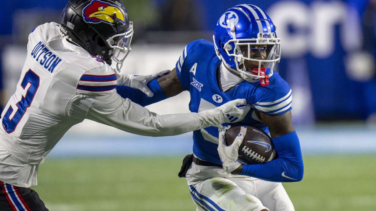 Kansas cornerback Mello Dotson (3) tackles BYU wide receiver Darius Lassiter (5) during the first half of an NCAA college football game Saturday, Nov. 16, 2024, in Provo.