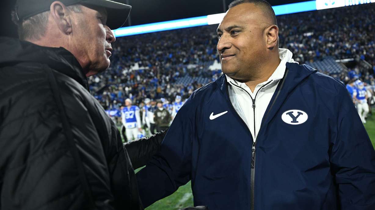Kansas Jayhawks head coach Lance Leipold and Brigham Young Cougars head coach Kalani Sitake shake hands after the Jayhawks handed BYU their first loss of the season at LaVell Edwards Stadium in Provo on Saturday Nov. 16, 2024. Kansas won 17-13.