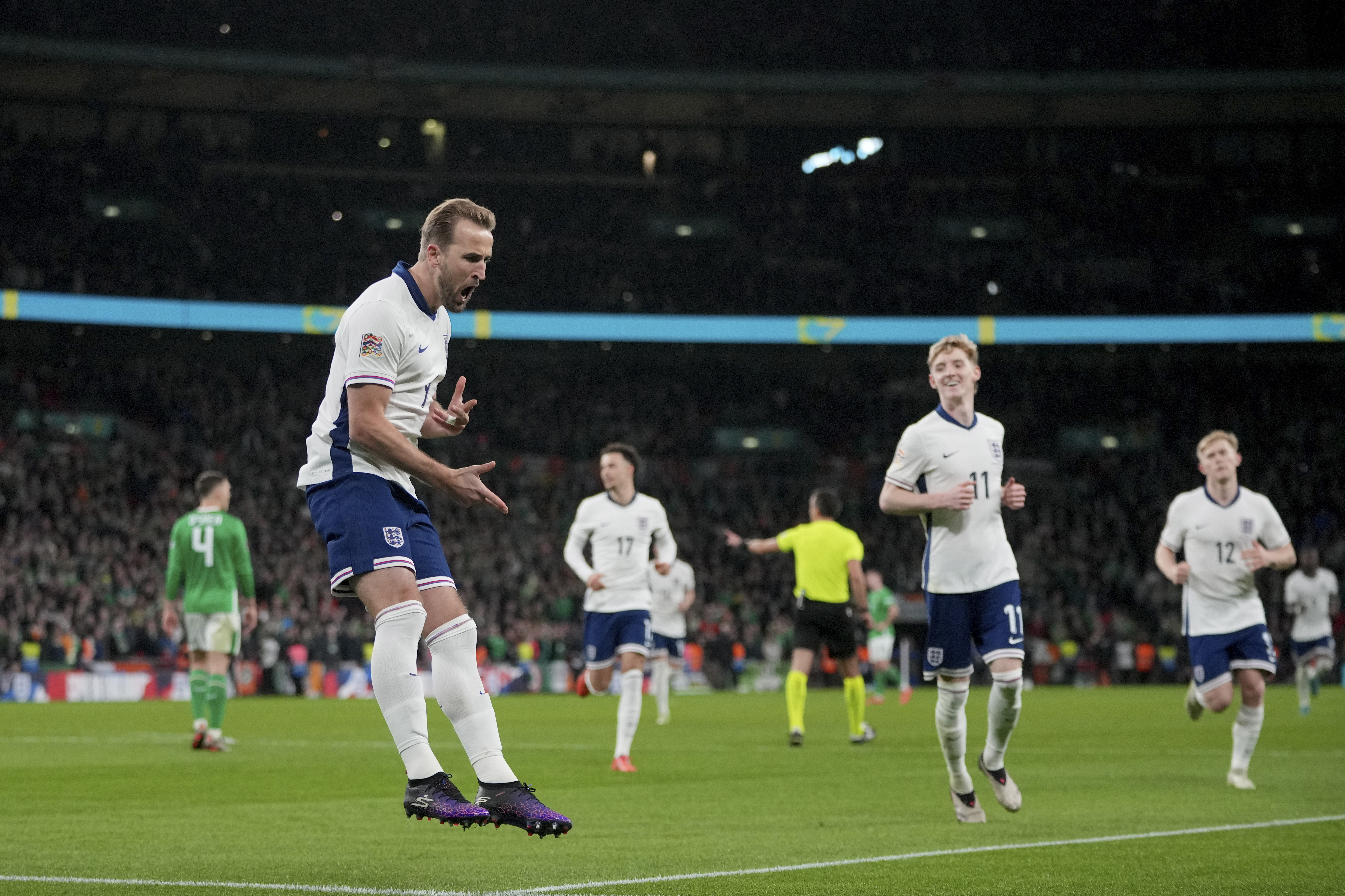 England's Harry Kane, left, celebrates after scoring the opening goal during the UEFA Nations League soccer match between England and the Republic of Ireland at Wembley stadium in London, Sunday, Nov. 17, 2024.