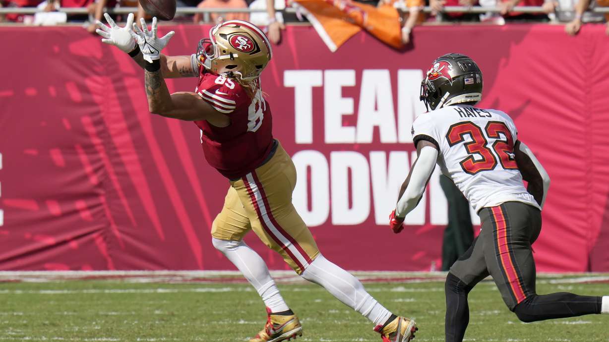 San Francisco 49ers tight end George Kittle (85) catches a pass against Tampa Bay Buccaneers safety Josh Hayes (32) during the first half of an NFL football game in Tampa, Fla., Sunday, Nov. 10, 2024.
