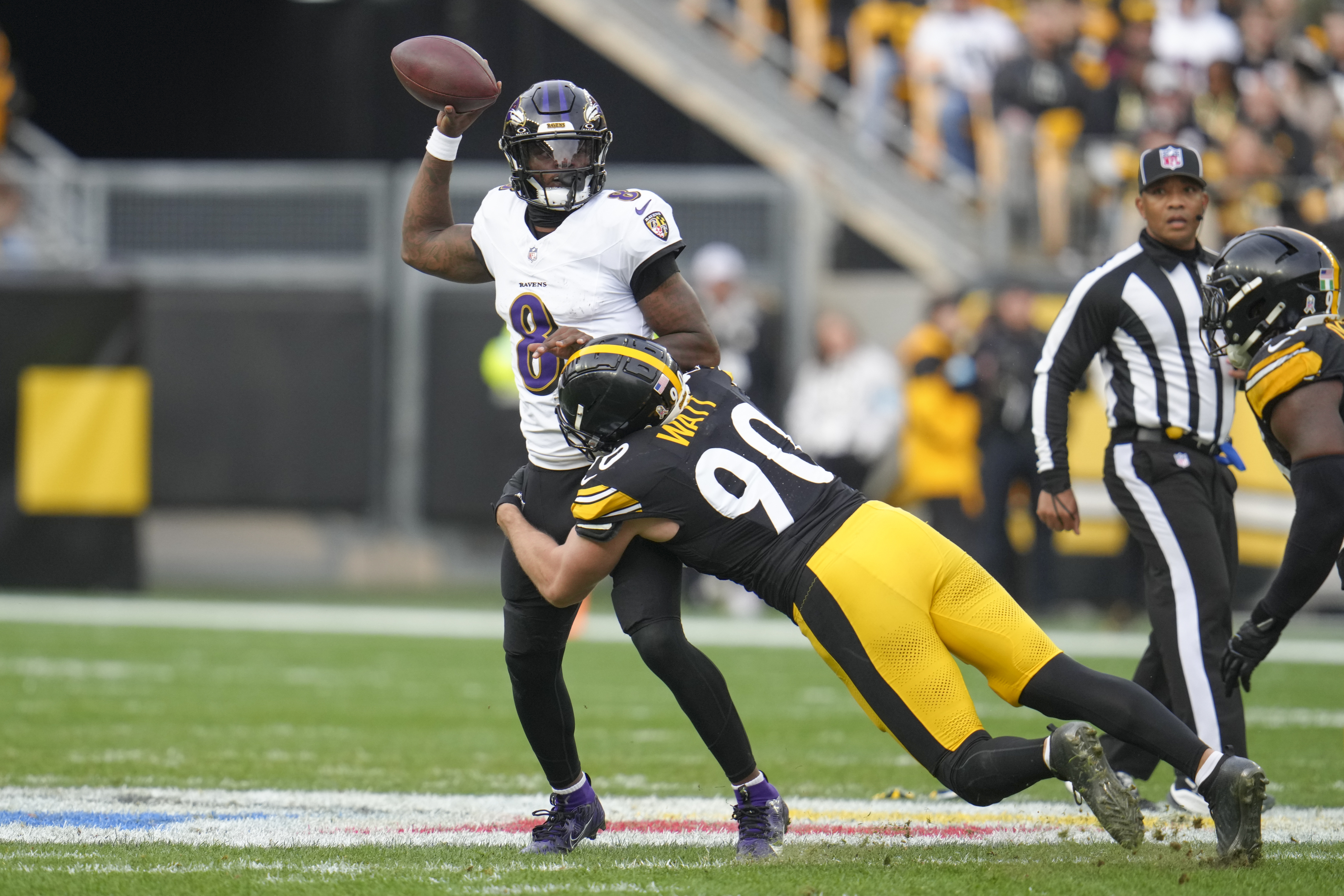 Baltimore Ravens quarterback Lamar Jackson (8) attempts a pass as Pittsburgh Steelers linebacker T.J. Watt (90) applies pressure during the second half of an NFL football game, Sunday, Nov. 17, 2024, in Pittsburgh.