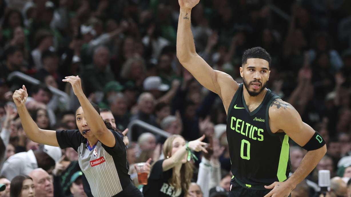 Boston Celtics forward Jayson Tatum (0) signals three after hitting an outside shot during the first half of an NBA basketball game against the Toronto Raptors, Saturday, Nov. 16, 2024, in Boston.