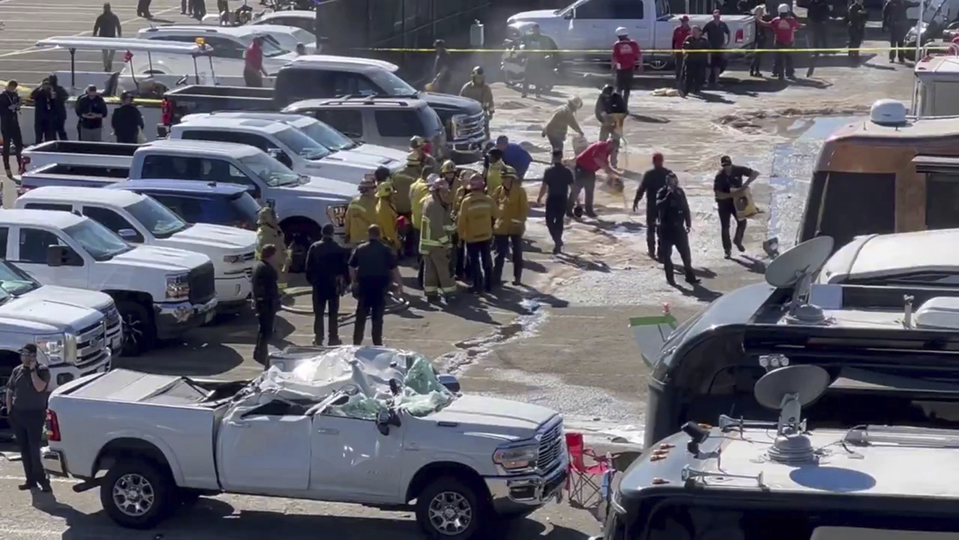 This image taken from video provided by Jerry Jordan shows the fire department and others working at the site of a single-engine plane crash Sunday, Nov. 17, 2024, near a Southern California racing event, in Pomona, Calif., about 30 miles (50 kilometers) east of downtown Los Angeles. 