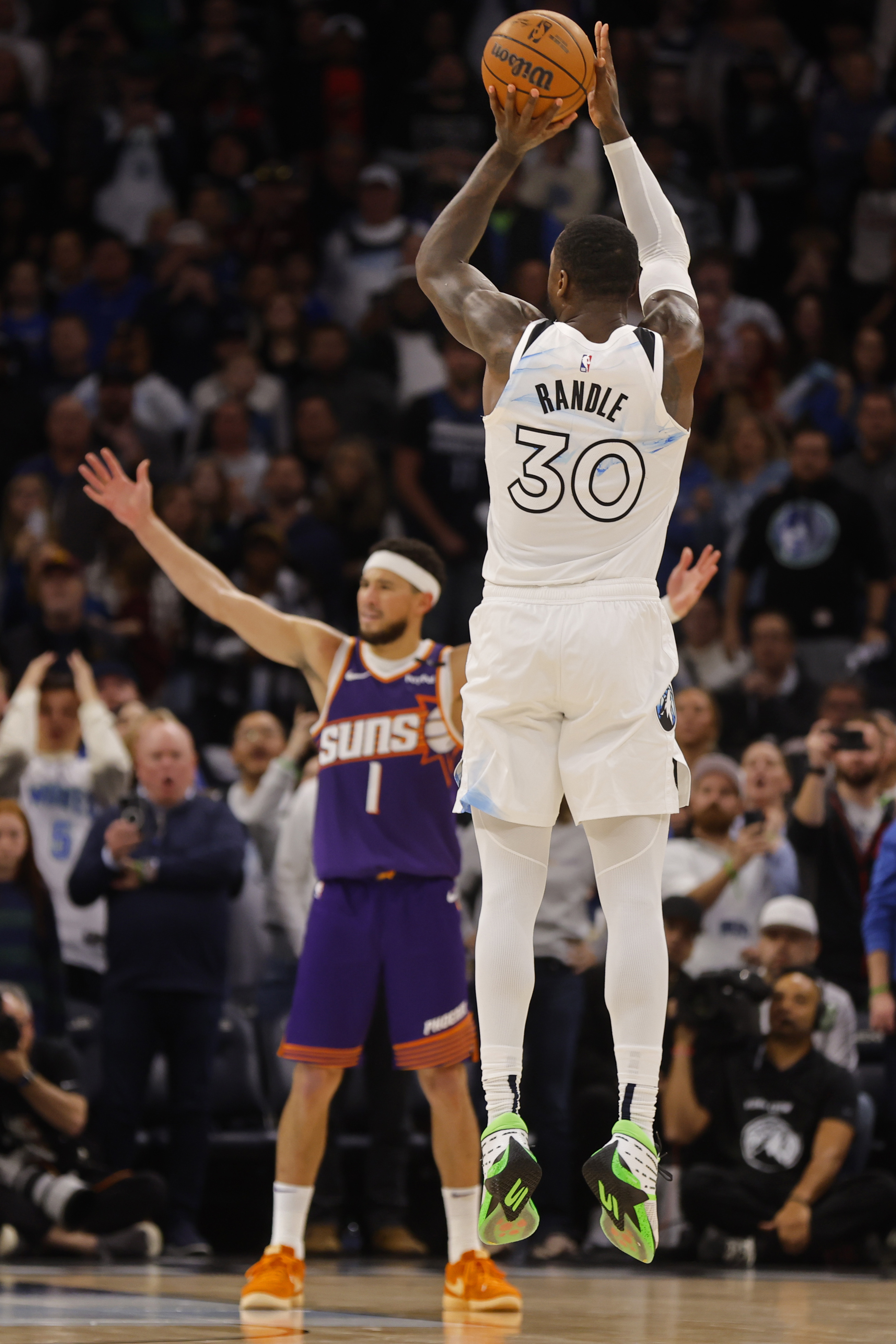 Minnesota Timberwolves forward Julius Randle (30) goes up to shoot a 3-point basket to defeat the Phoenix Suns as time ends in the fourth quarter of an NBA basketball game Sunday, Nov. 17, 2024, in Minneapolis. 