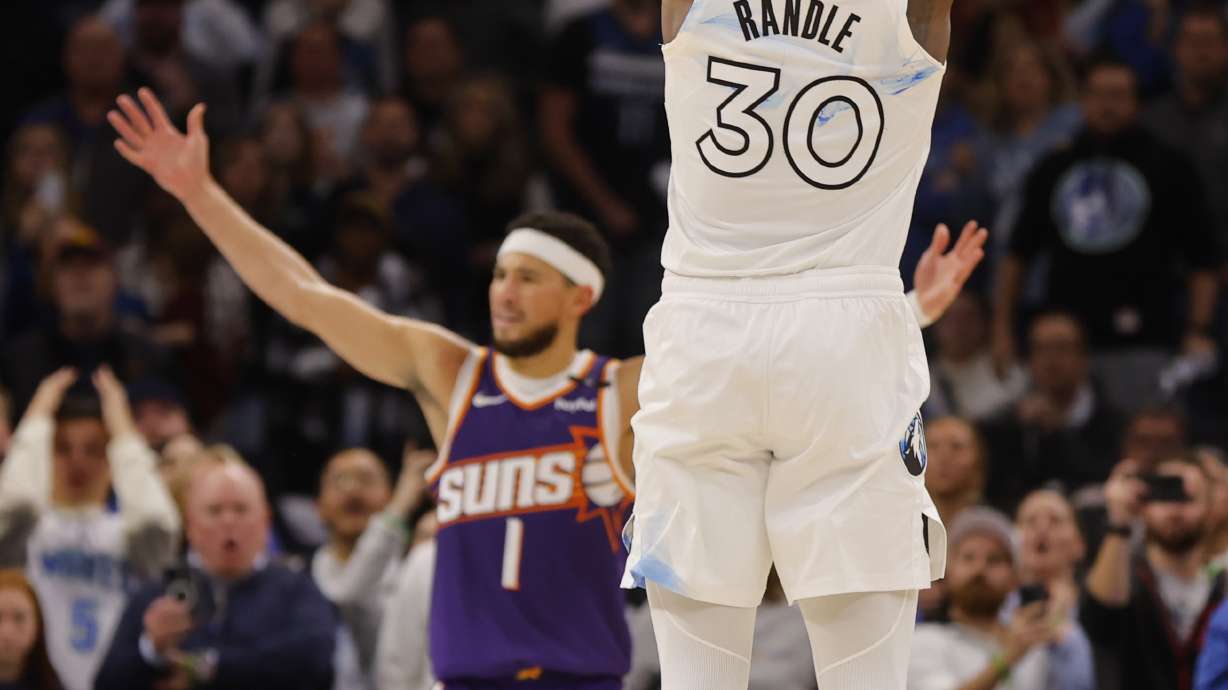 Minnesota Timberwolves forward Julius Randle (30) goes up to shoot a 3-point basket to defeat the Phoenix Suns as time ends in the fourth quarter of an NBA basketball game Sunday, Nov. 17, 2024, in Minneapolis.
