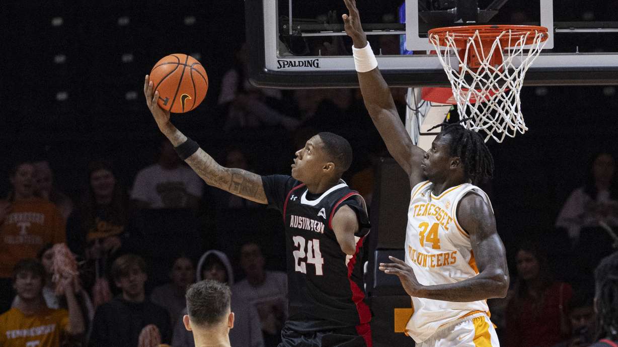 Austin Peay guard Hansel Enmanuel (24) shoots past Tennessee forward Felix Okpara (34) during the second half of an NCAA college basketball game Sunday, Nov. 17, 2024, in Knoxville, Tenn.