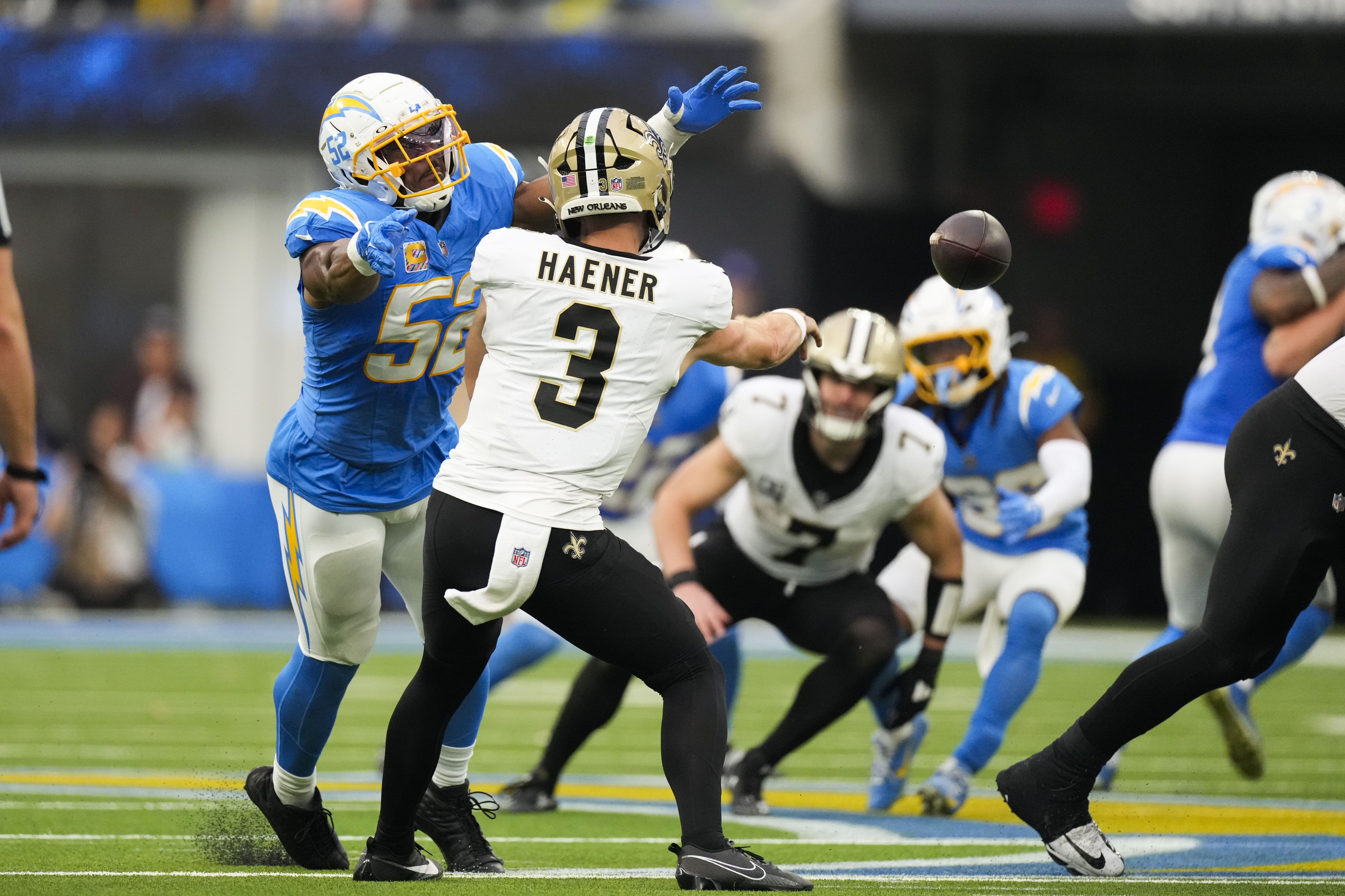 New Orleans Saints quarterback Jake Haener (3) passes under pressure rom Los Angeles Chargers linebacker Khalil Mack (52) in the second half of an NFL football game in Inglewood, Calif., Sunday, Oct. 27, 2024. 