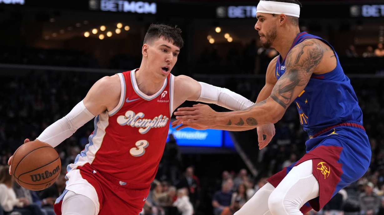 Memphis Grizzlies forward Jake LaRavia (3) drives against Denver Nuggets' Michael Porter Jr., right, in the first half of an NBA basketball game Sunday, Nov. 17, 2024, in Memphis, Tenn.