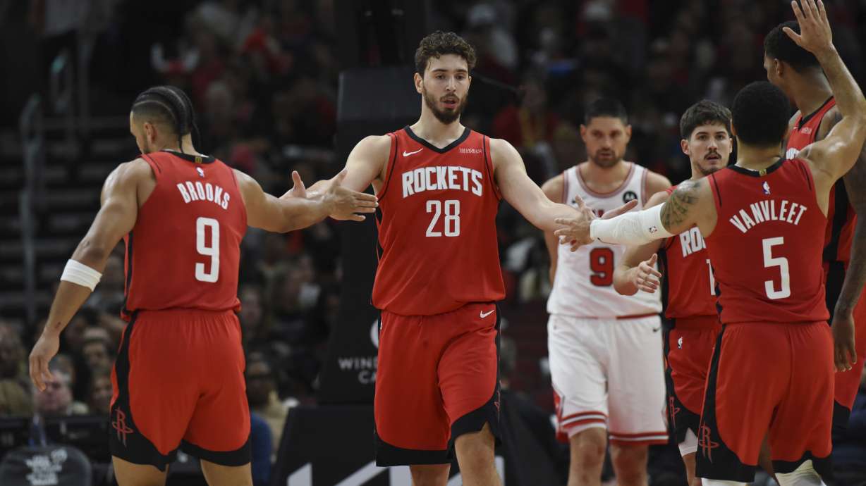 Houston Rockets' Alperen Sengun (28), celebrates with teammates Dillon Brooks (9), and Fred VanVleet (5), during the first half of an NBA basketball game against the Chicago Bulls Sunday, Nov. 17, 2024, in Chicago.