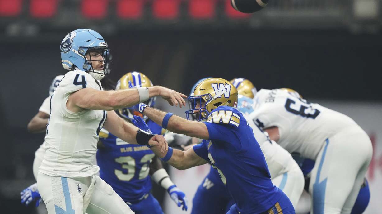 Toronto Argonauts quarterback Nick Arbuckle (4) passes against the Winnipeg Blue Bombers during the second half of a CFL football game at the 111th Grey Cup in Vancouver, British Columbia, Sunday, Nov. 17, 2024.