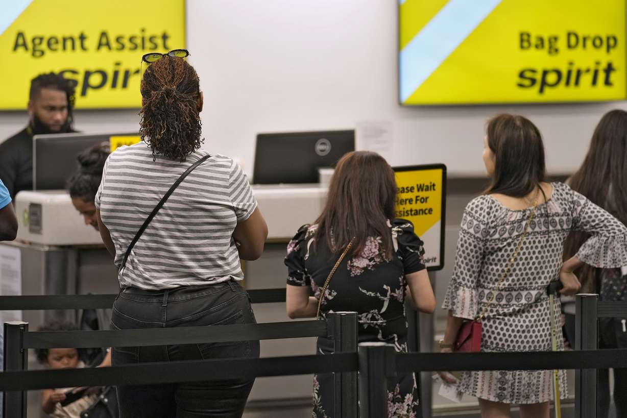 Passengers wait in a line for help at the Spirit Airlines ticket counter at the Tampa International Airport June 1, 2023, in Tampa, Fla. The airline has filed for bankruptcy.