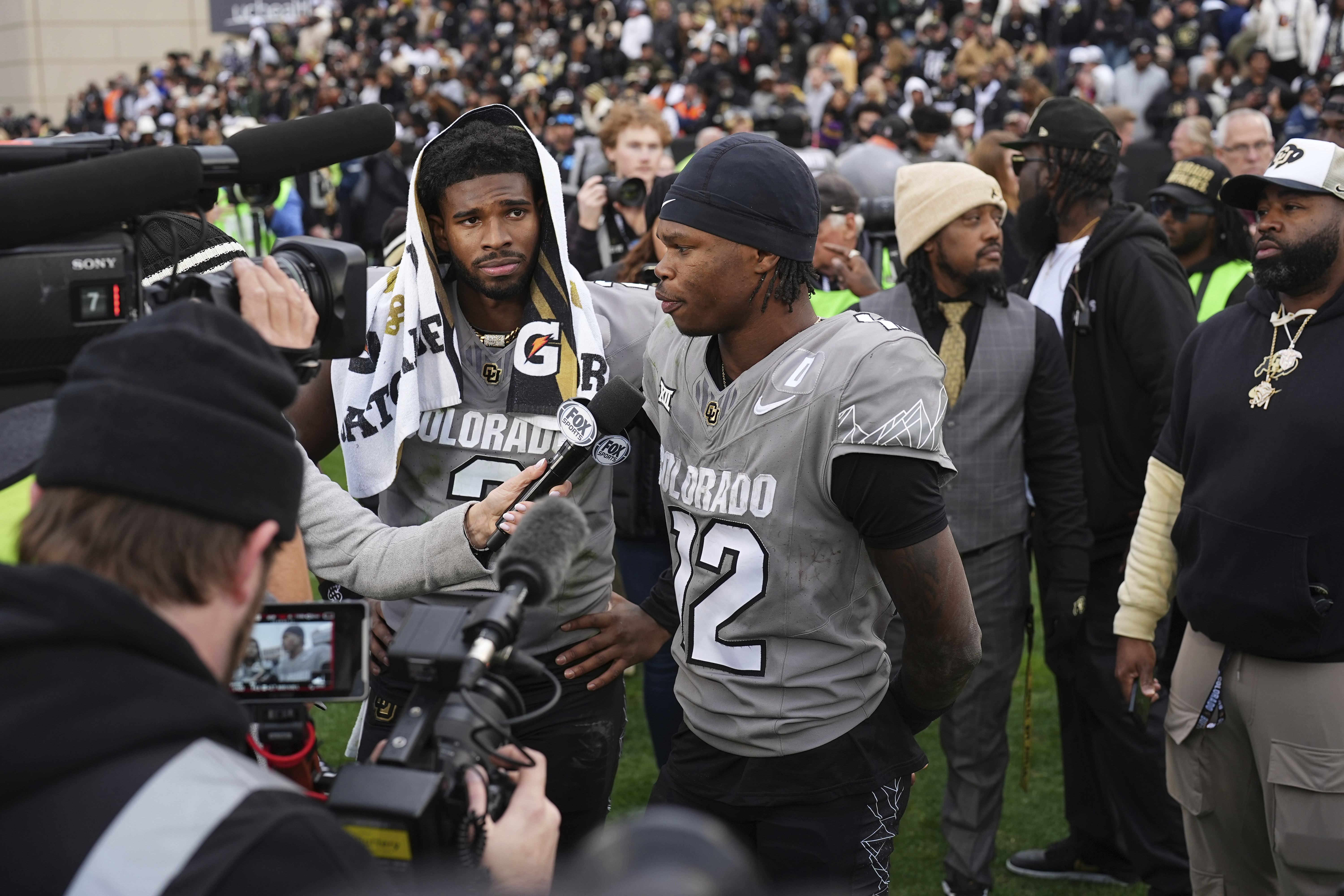 Colorado wide receiver Travis Hunter, right, answers a question as quarterback Shedeur Sanders looks on as the pair are interviewed following an NCAA college football game against Utah, Saturday, Nov. 16, 2024, in Boulder, Colo. 