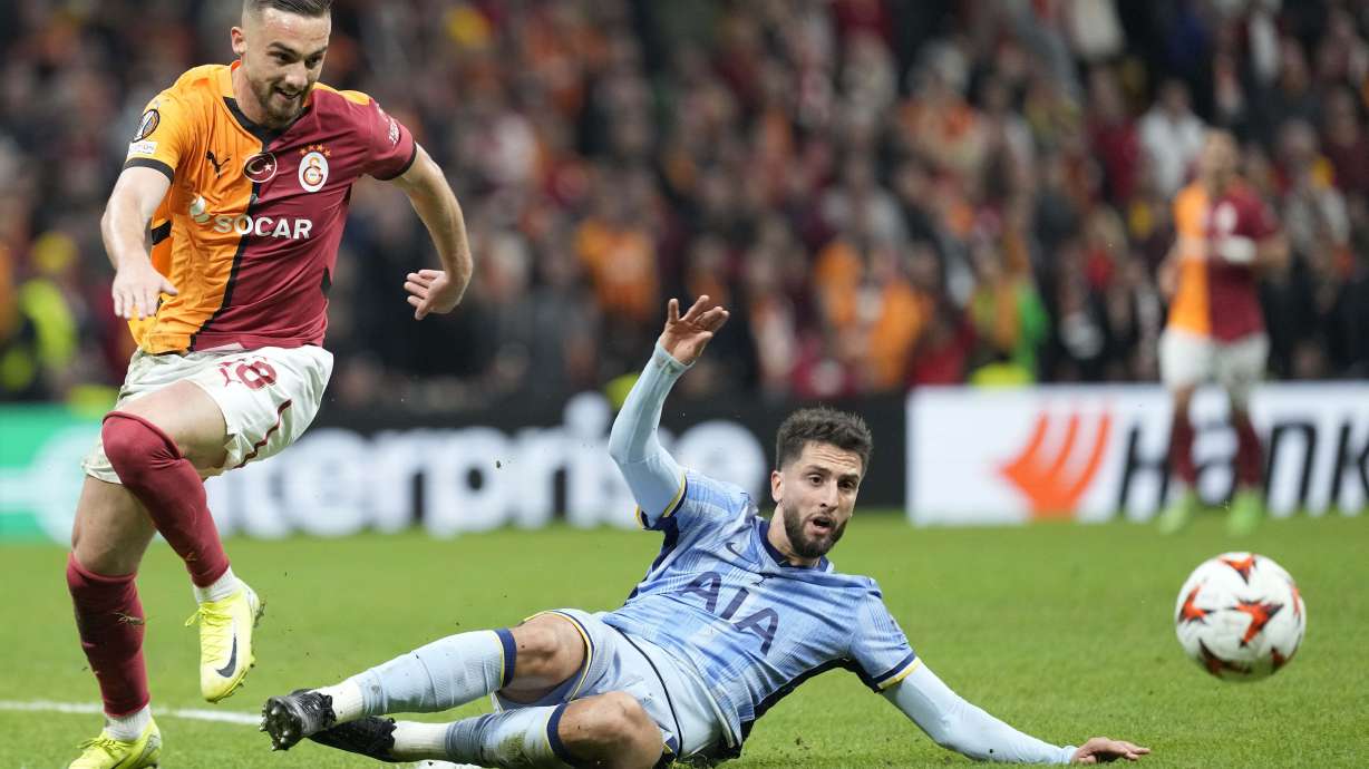 Galatasaray's Berkan Kutlu challenges for the ball Tottenham's Rodrigo Bentancur during the Europa League opening phase soccer match between Galatasaray and Tottenham Hotspur at Ali Sami Yen stadium, in Istanbul, Turkey, Thursday, Nov. 7, 2024.