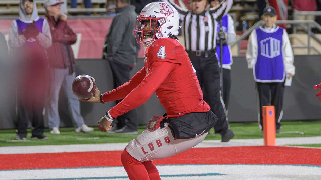 New Mexico's quarterback Devon Dampier runs into the end zone for a go ahead touchdown late in the fourth quarter against Washington State during an NCAA college football game Saturday, Nov. 16, 2024 in Albuquerque, N.M.