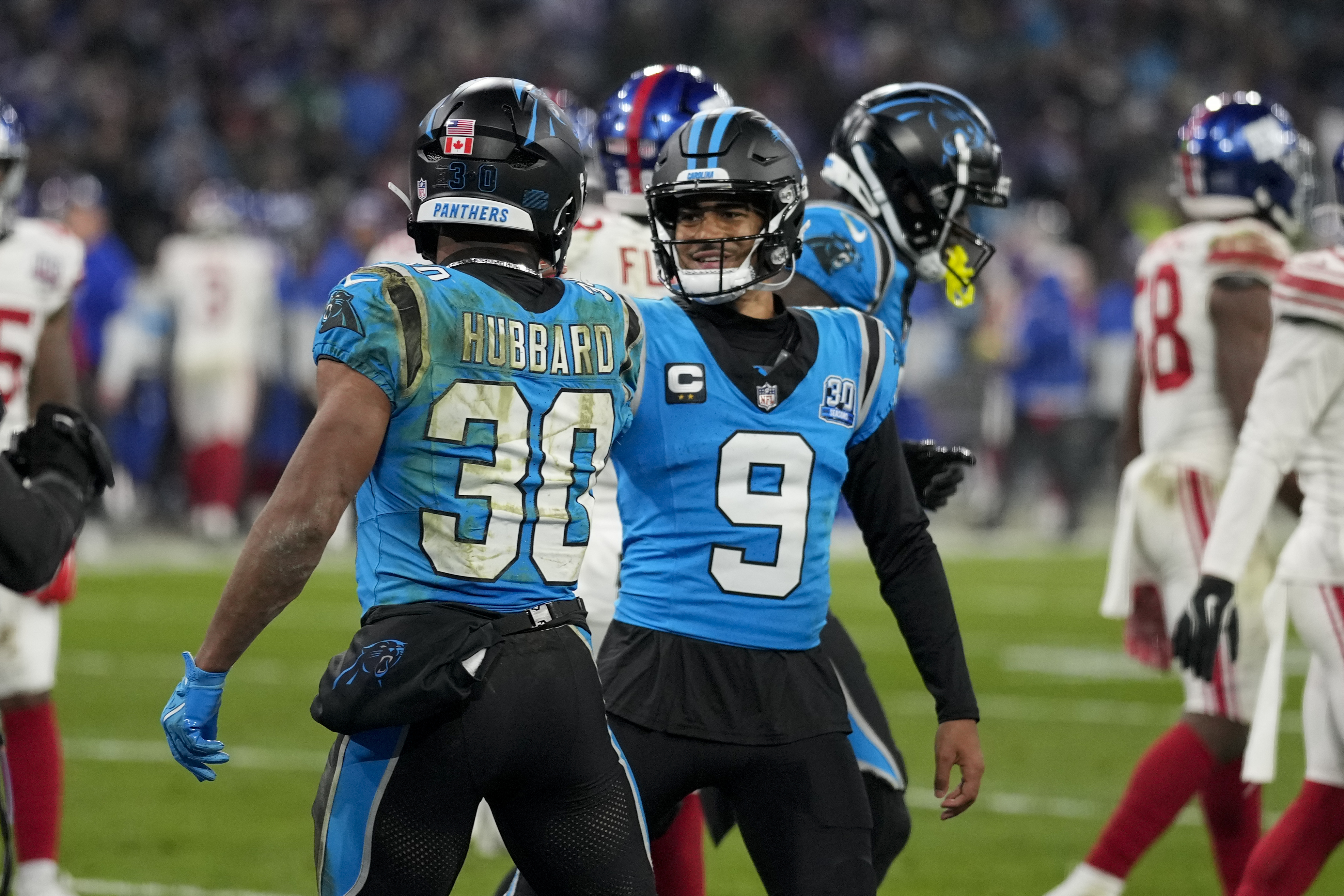 Carolina Panthers running back Chuba Hubbard celebrates his touchdown with quarterback Bryce Young during the second half of an NFL football game against the New York Giants, Sunday, Nov. 10, 2024, in Munich, Germany. 