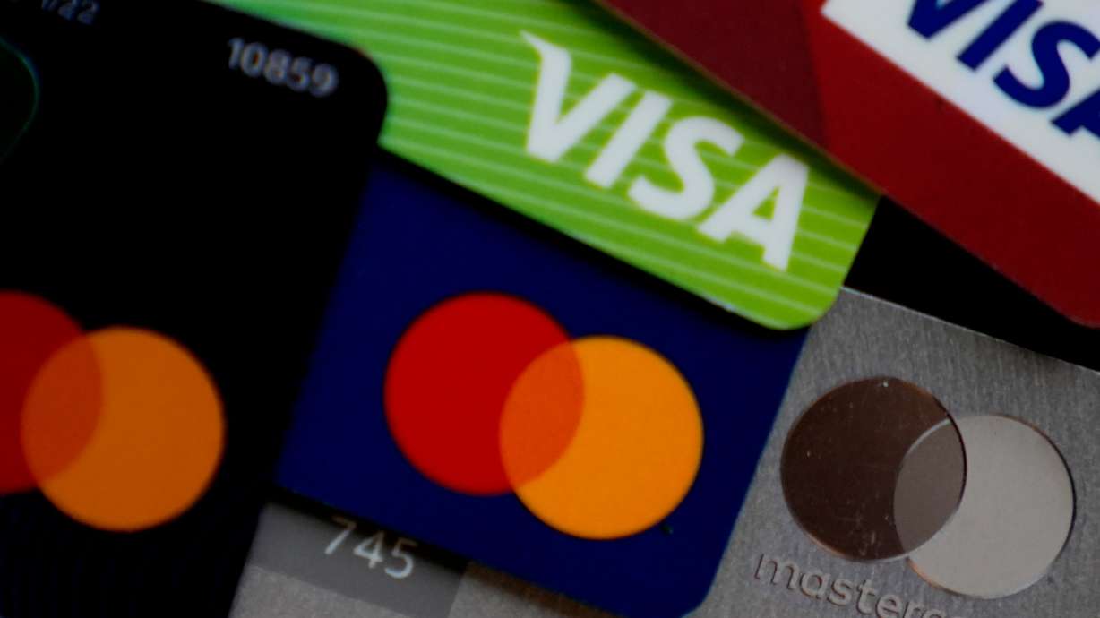 Several VISA and MASTER credit cards are shown in Buffalo Grove, Ill., Feb. 8. The Federal Reserve Bank of New York's latest quarterly report on household debt and credit reported a $147 billion increase in household debt, resulting in a national sum of $17.94 trillion.