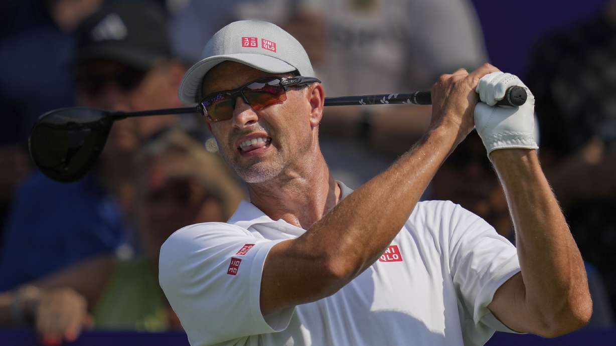 Adam Scott of Australia reacts after hitting off the first tee during the first round of World Tour Golf Championship in Dubai, United Arab Emirates, Thursday, Nov. 14, 2024.
