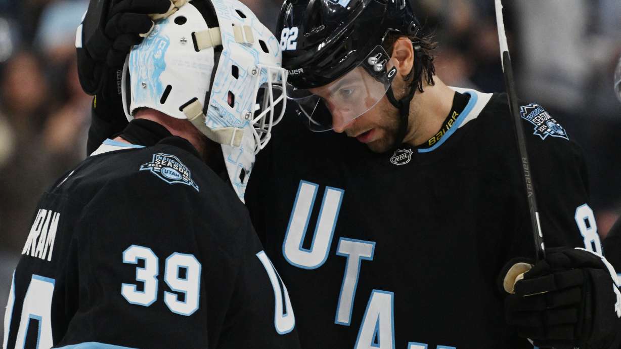Utah Hockey Club goaltender Connor Ingram, left, and Utah Hockey Club center Kevin Stenlund congratulate each other after the Utah Hockey Club defeated the Boston Bruins 2-1 in overtime at the Delta Center in Salt Lake City on Oct. 19.