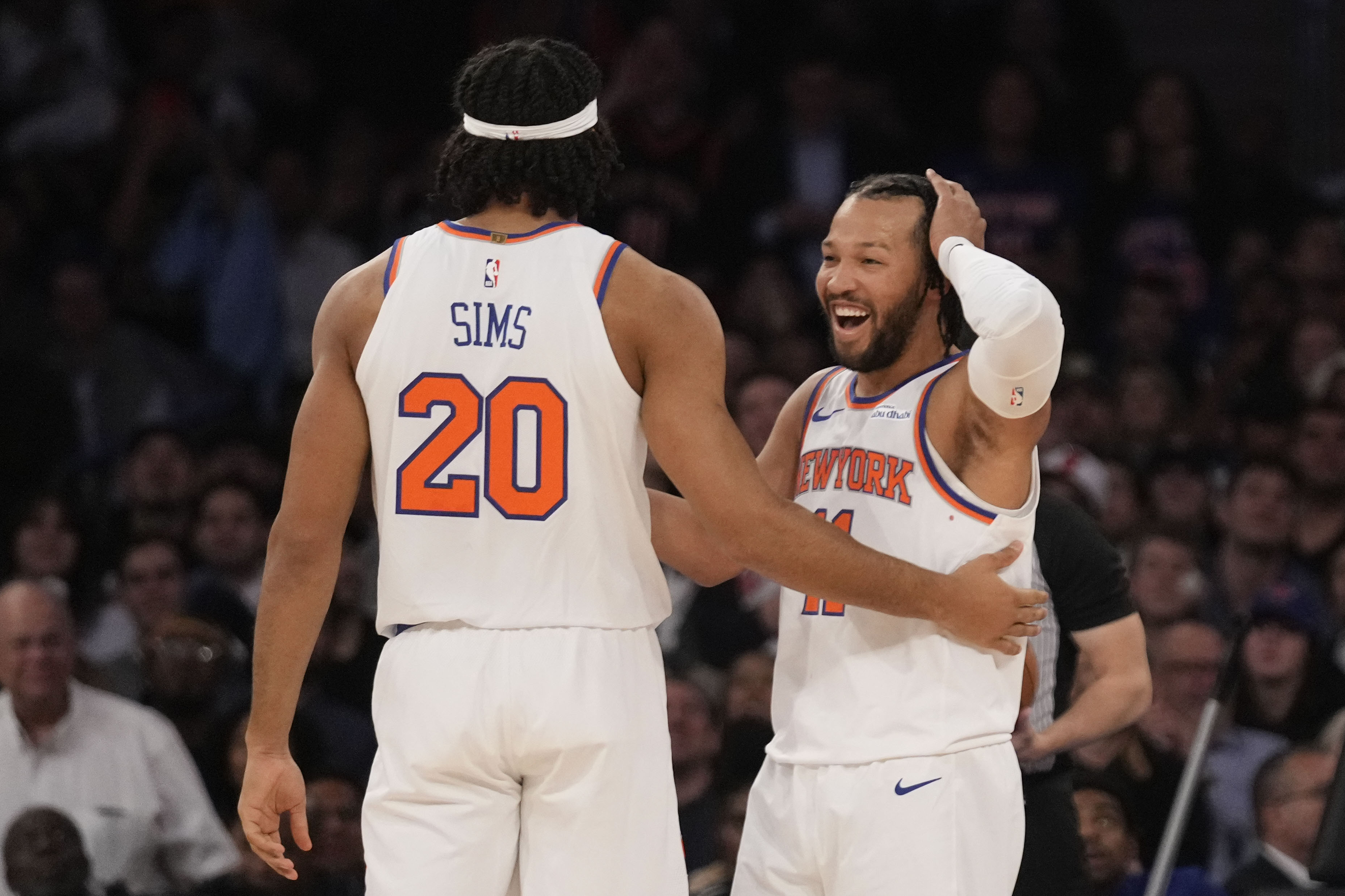 New York Knicks' Jalen Brunson, right, celebrates with teammate Jericho Sims after Sims dunked the ball during the first half of an NBA basketball game against the Washington Wizards, Monday, Nov. 18, 2024, in New York. 