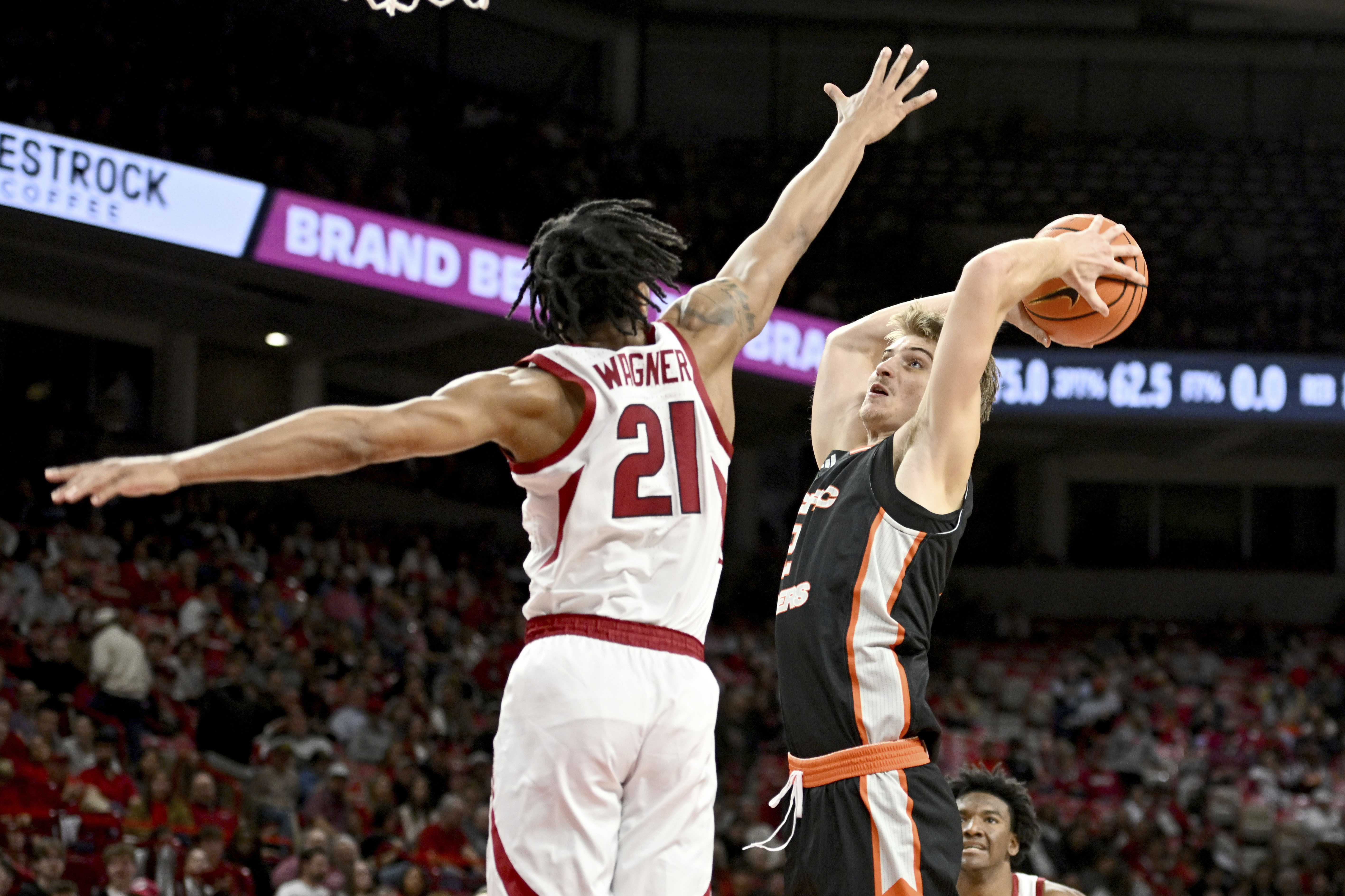 Pacific forward Elias Ralph (2) drives past Arkansas guard D.J. Wagner (21) to score during the first half of an NCAA college basketball game Monday, Nov. 18, 2024, in Fayetteville, Ark. 