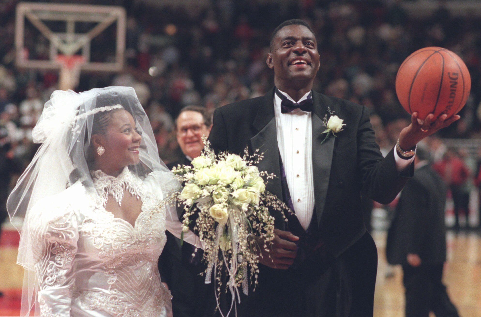 FILE - Former Chicago Bulls star Bob Love prepares to shoot a basket after his wedding to Rachel Dixon during halftime of the Bulls' game against the San Antonio Spurs, Dec. 8, 1995, at Chicago United Center.