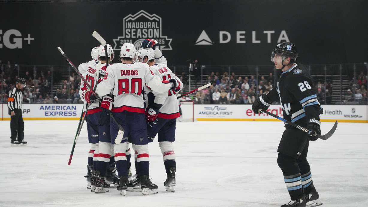 The Washington Capitals celebrate a goal as Utah Hockey Club defenseman Ian Cole (28) reacts during the second period of an NHL hockey game Monday, Nov. 18, 2024, in Salt Lake City.