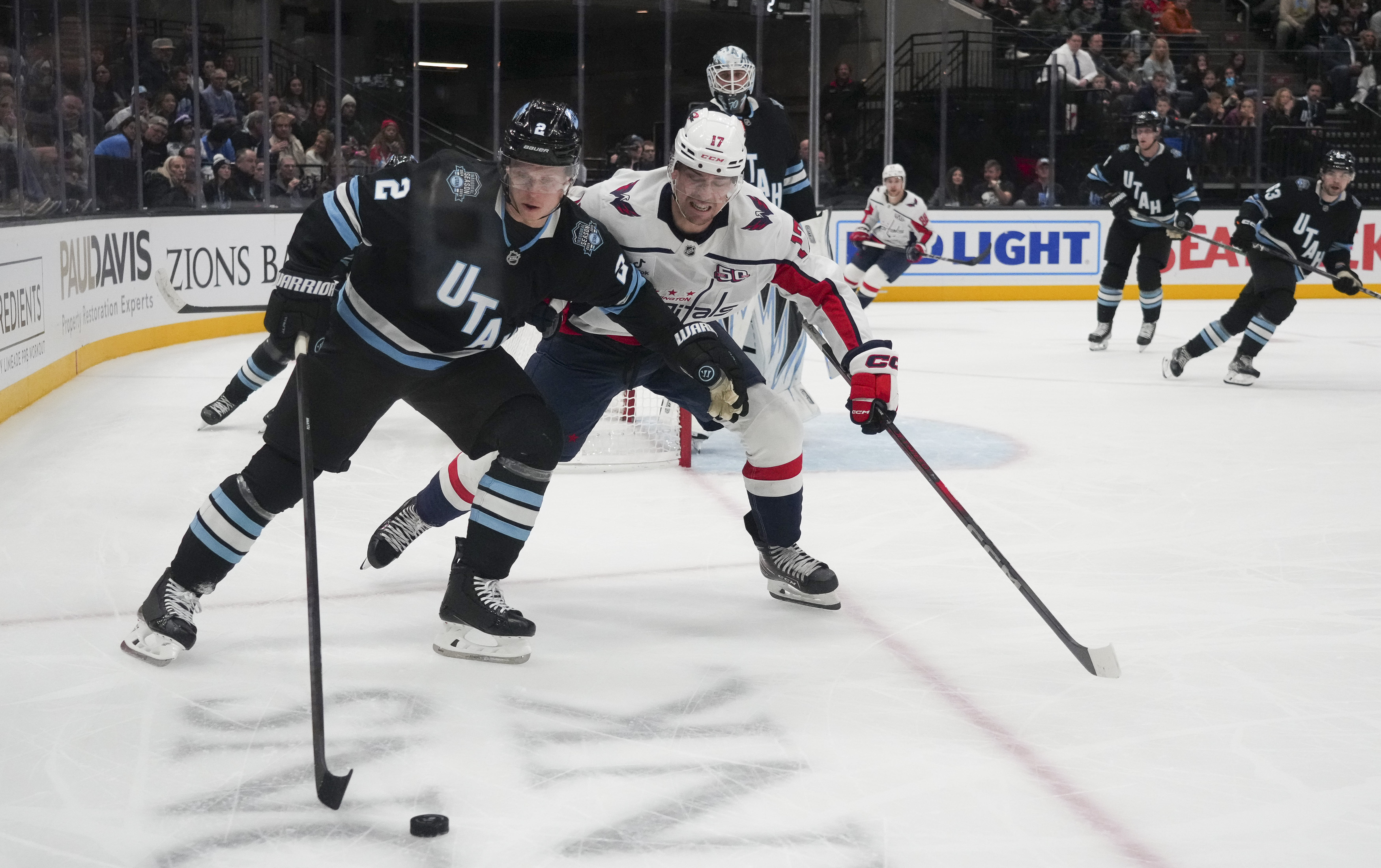 Utah Hockey Club defenseman Olli Maatta (2) and Washington Capitals center Dylan Strome (17) vie for the puck during the second period of an NHL hockey game Monday, Nov. 18, 2024, in Salt Lake City.