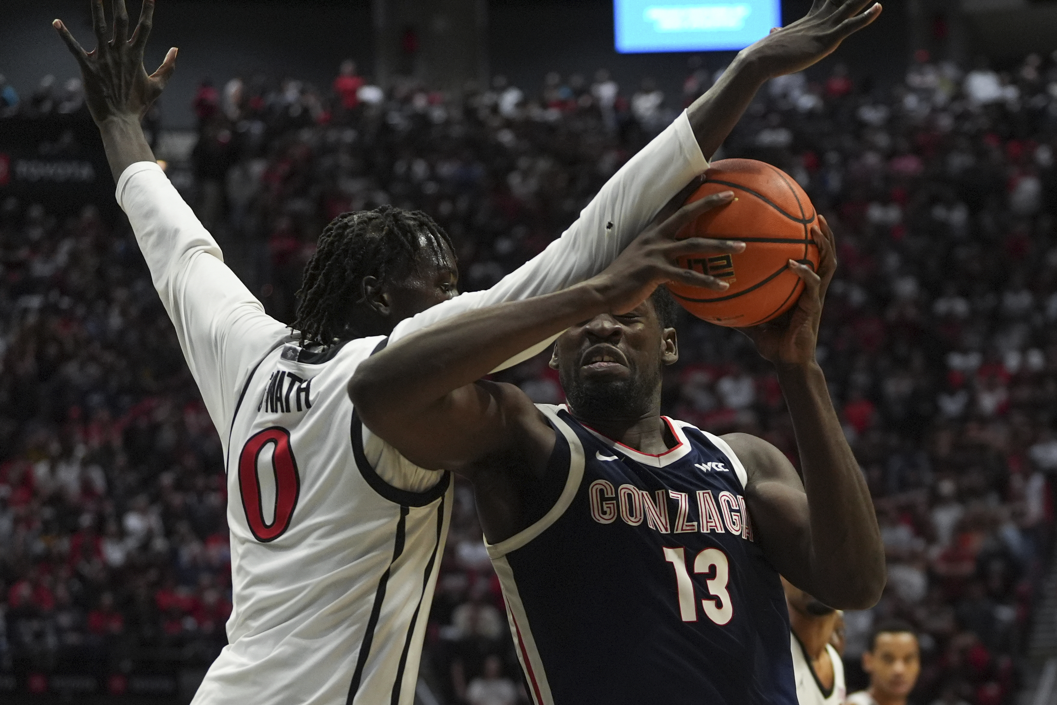 Gonzaga forward Graham Ike (13) is fouled by San Diego State forward Magoon Gwath during the first half of an NCAA college basketball game Monday, Nov. 18, 2024, in San Diego.