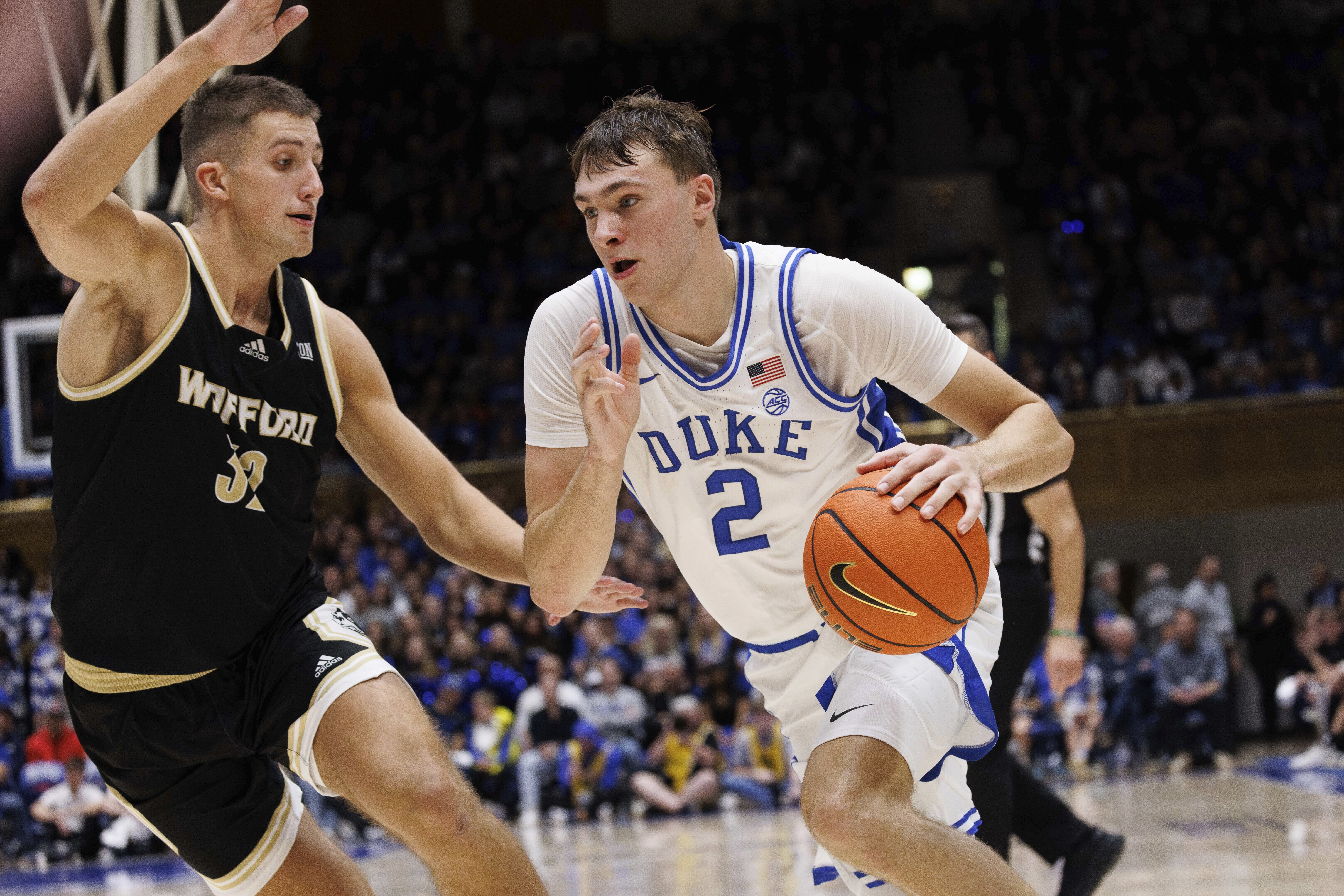 Duke's Cooper Flagg (2) drives as Wofford's Jeremy Lorenz (32) defends during the second half of an NCAA college basketball game in Durham, N.C., Saturday, Nov. 16, 2024. 