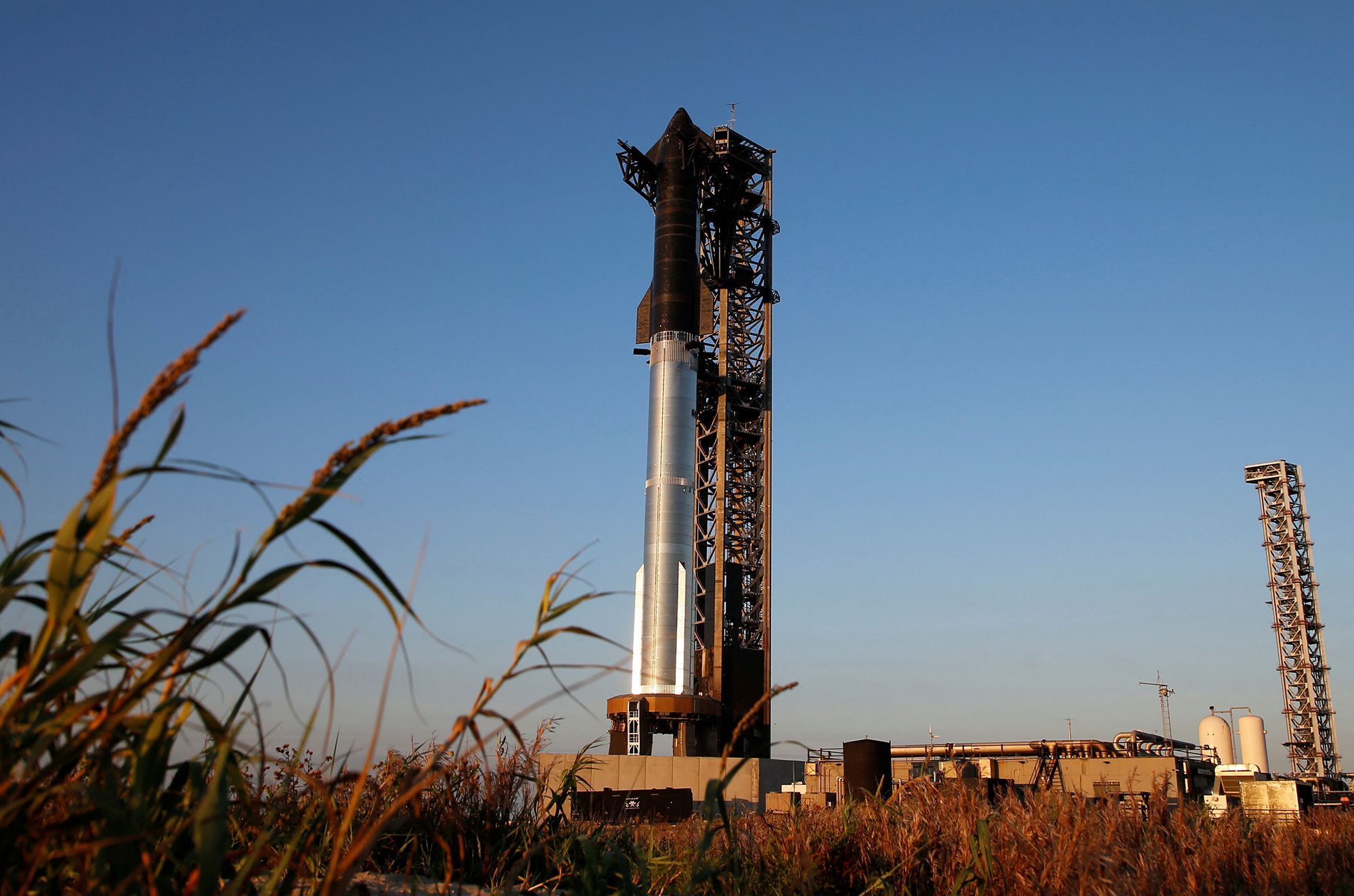 SpaceX's next-generation Starship spacecraft awaits a sixth flight test at the company's launchpad near Brownsville, Texas, Saturday. The company abandoned its second attempt at a booster catch due to unfavorable conditions Tuesday.