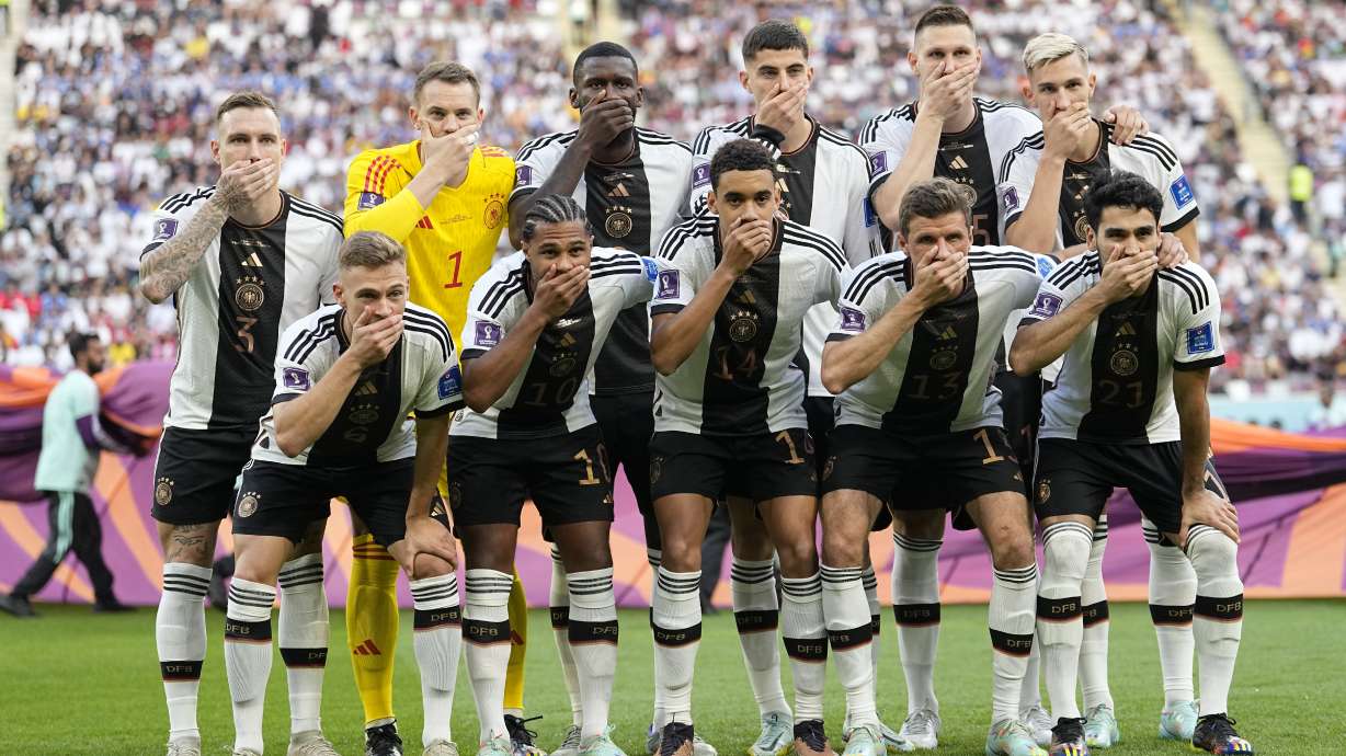 FILE - Players from Germany pose for the team photo as they cover their mouth prior to the World Cup group E soccer match between Germany and Japan, at the Khalifa International Stadium in Doha, Qatar, Nov. 23, 2022.
